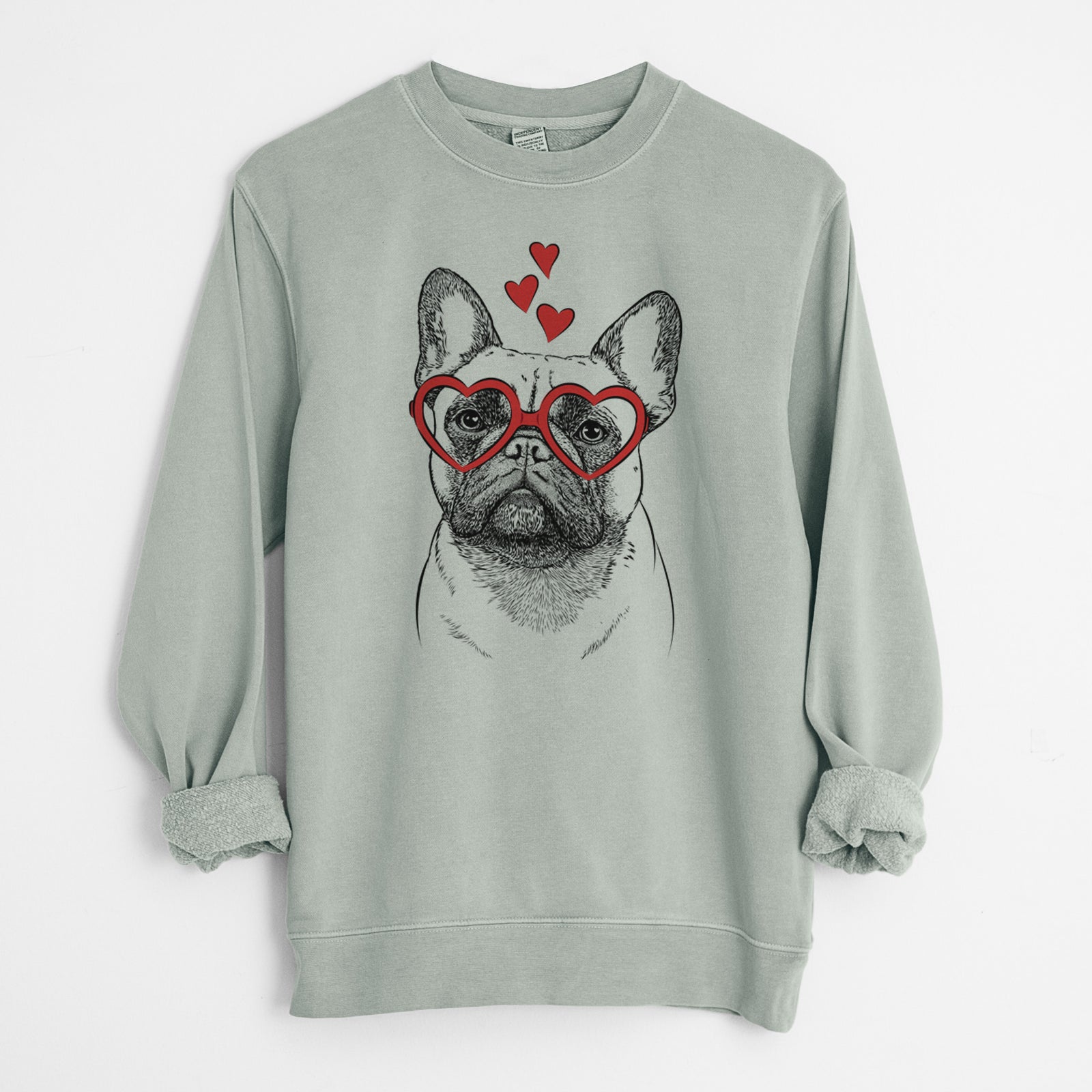 Hand-drawn sketch of Kingsleigh the French Bulldog wearing heart-shaped glasses on a Sage Unisex pigment dyed crew sweatshirt