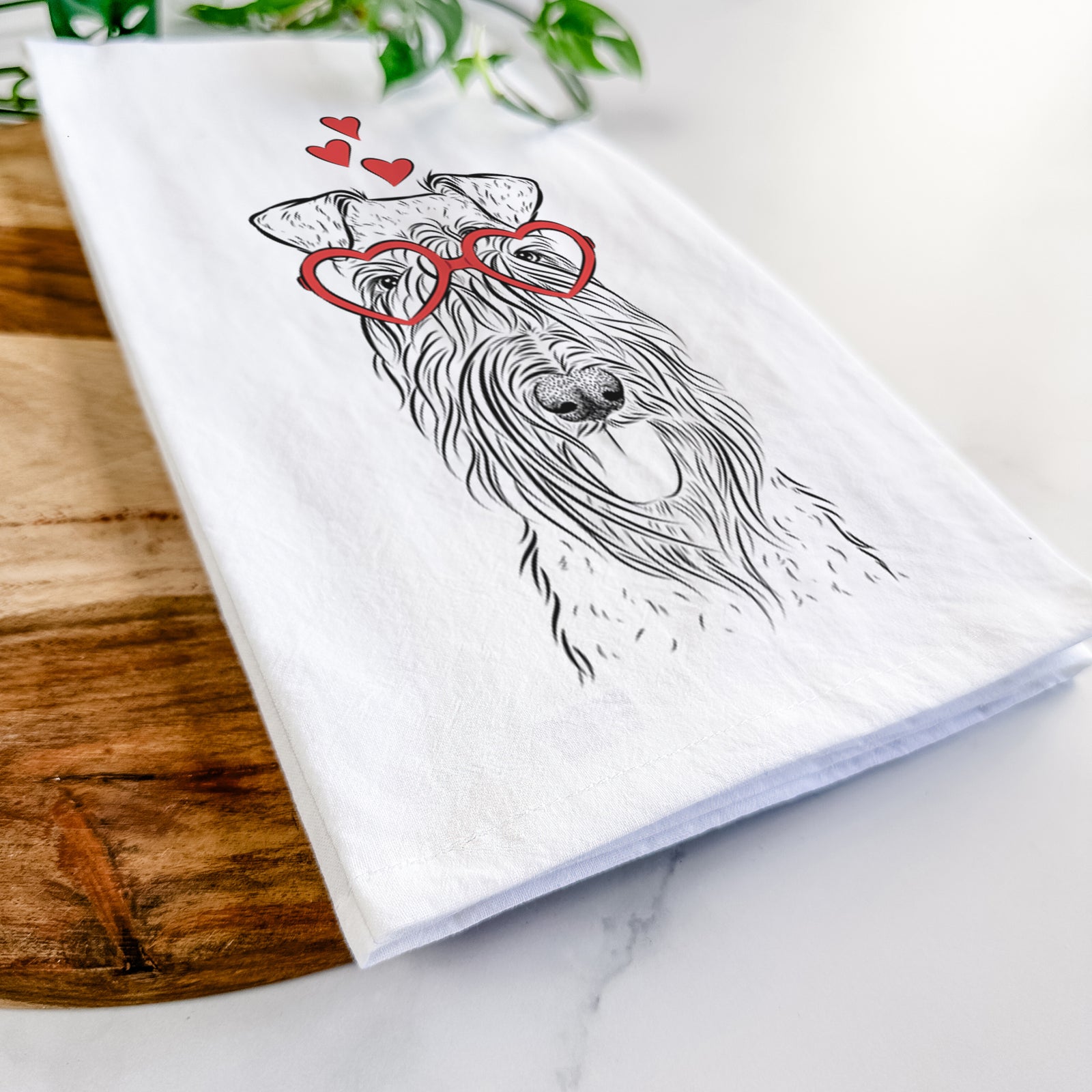 Hand-drawn sketch of Kricket the Kerry Blue Terrier wearing heart-shaped glasses on a tea towel