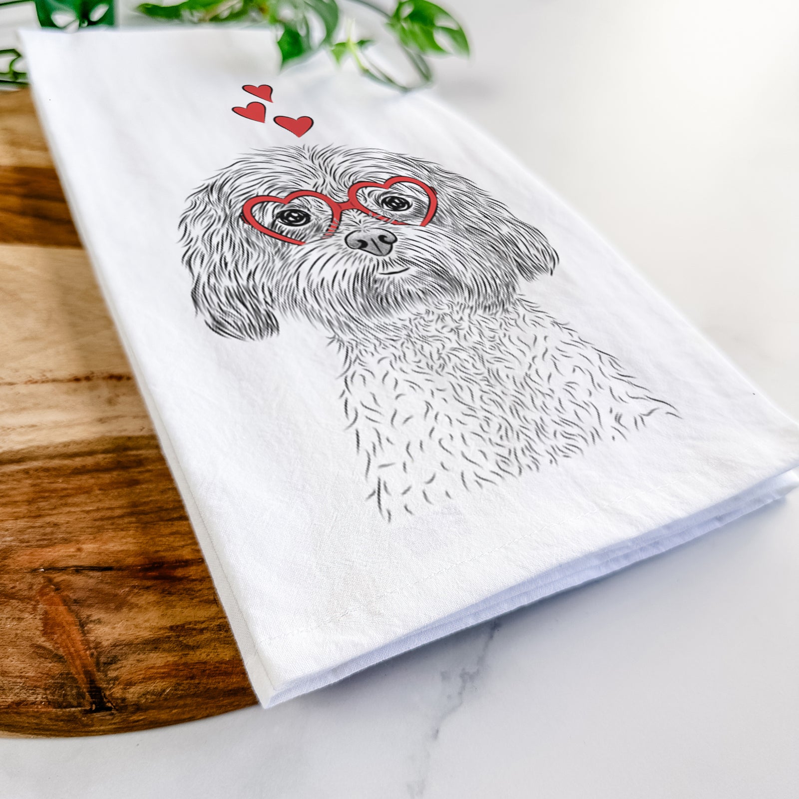 Hand-drawn sketch of Lane the Lhasa Apso wearing heart-shaped glasses on a tea towel