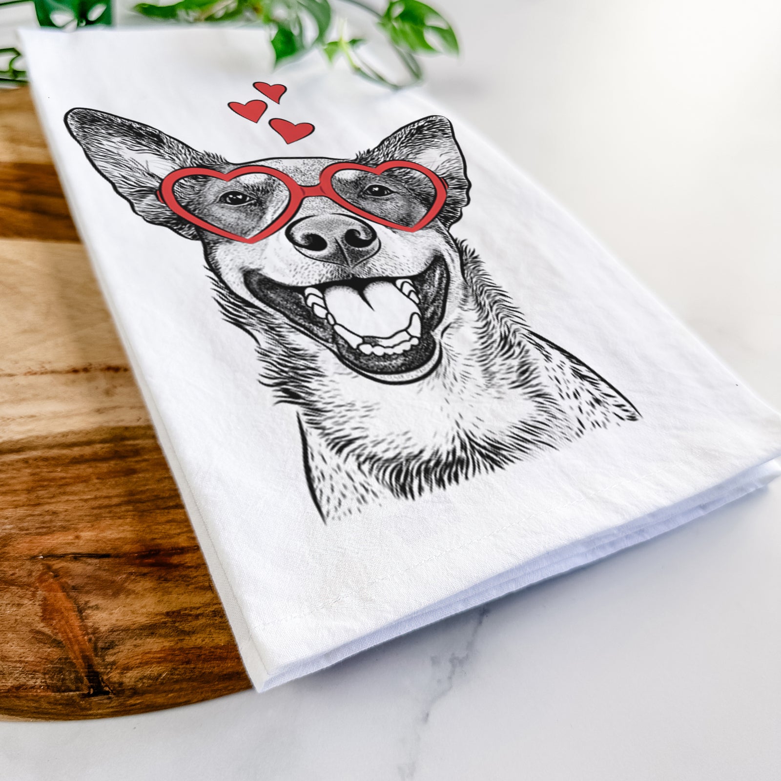 Hand-drawn sketch of Lily the Australian Cattle Dog wearing heart-shaped glasses on a tea towel