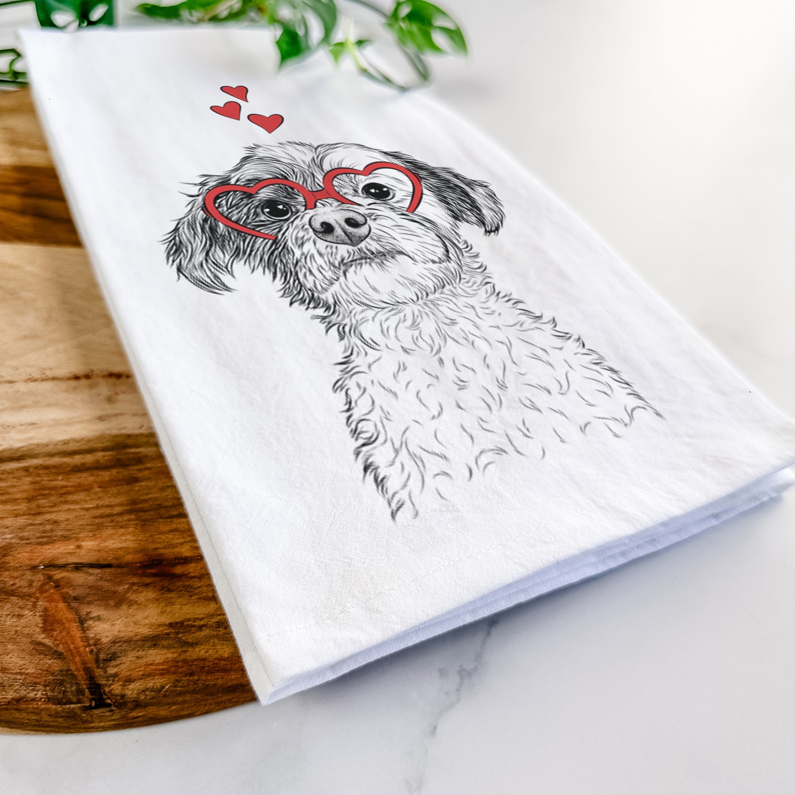 Hand-drawn sketch of Louise the Havanese wearing heart-shaped glasses on a tea towel