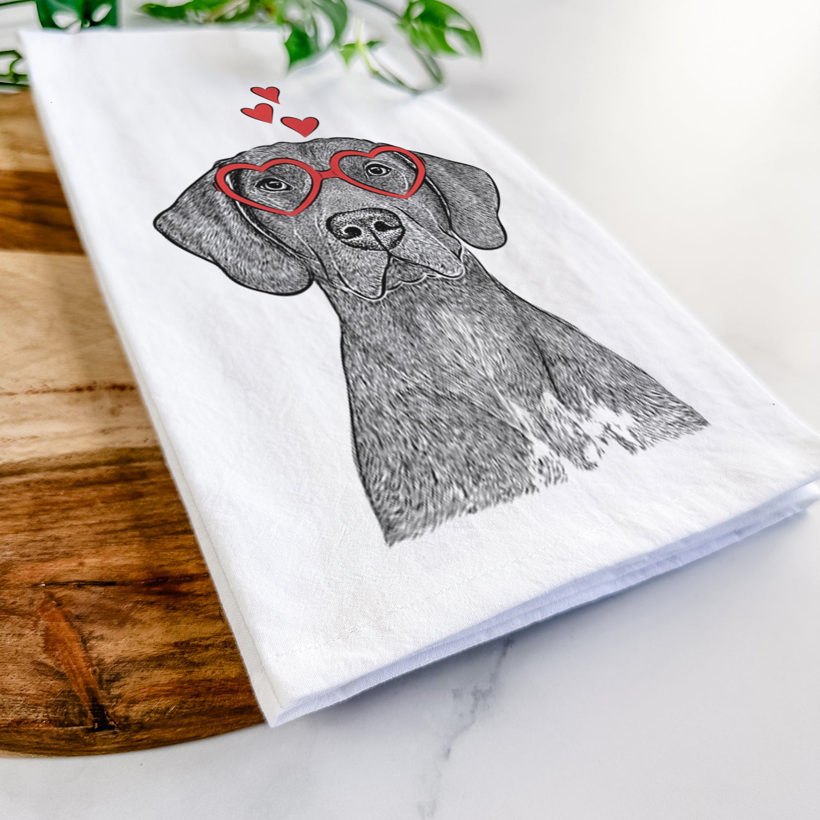 Hand-drawn sketch of Lucifer the German Shorthaired Pointer wearing heart-shaped glasses on a tea towel
