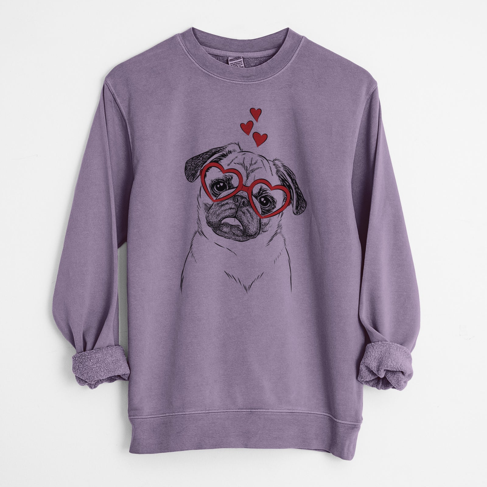 Hand-drawn sketch of Macy the Pug wearing heart-shaped glasses on a Plum Unisex pigment dyed crew sweatshirt
