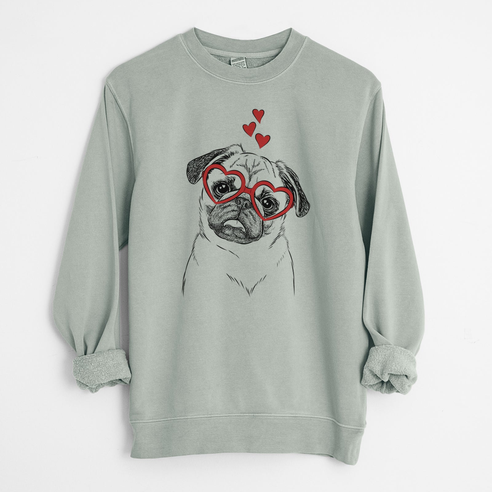 Hand-drawn sketch of Macy the Pug wearing heart-shaped glasses on a Sage Unisex pigment dyed crew sweatshirt