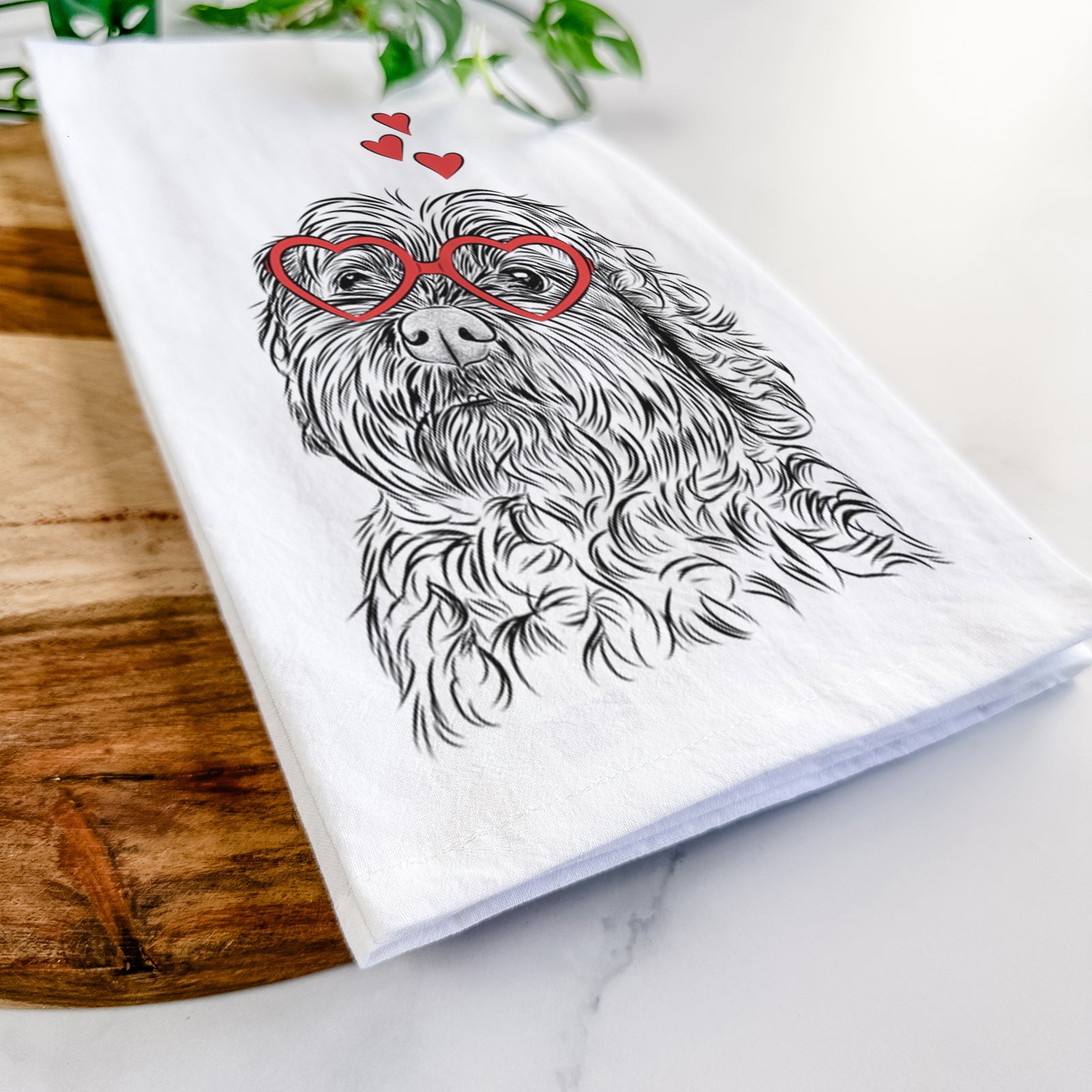 Hand-drawn sketch of Maggie Girl the Cockapoo wearing heart-shaped glasses on a tea towel