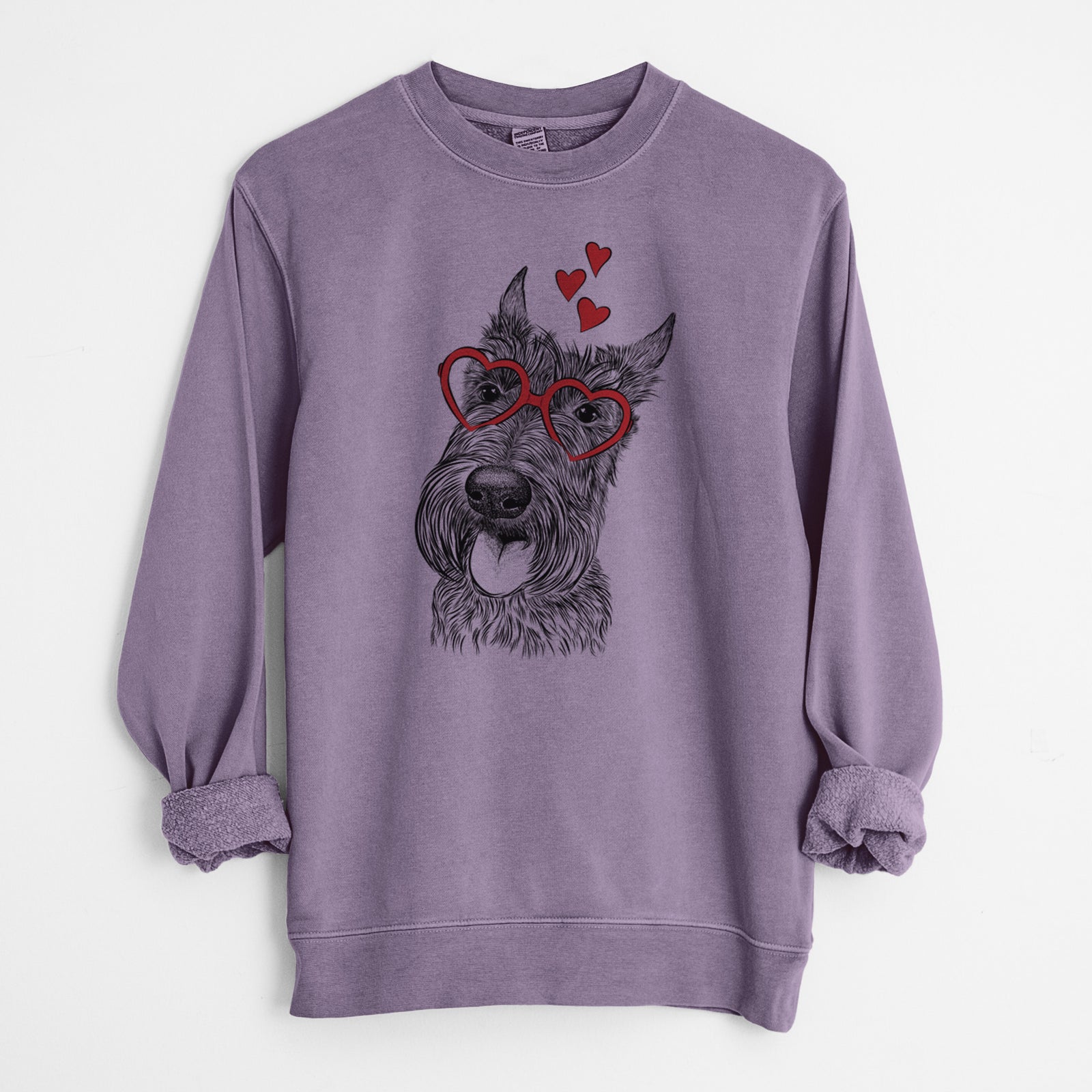 Hand-drawn sketch of Magnus the Scottish Terrier wearing heart-shaped glasses on a Plum Unisex pigment dyed crew sweatshirt
