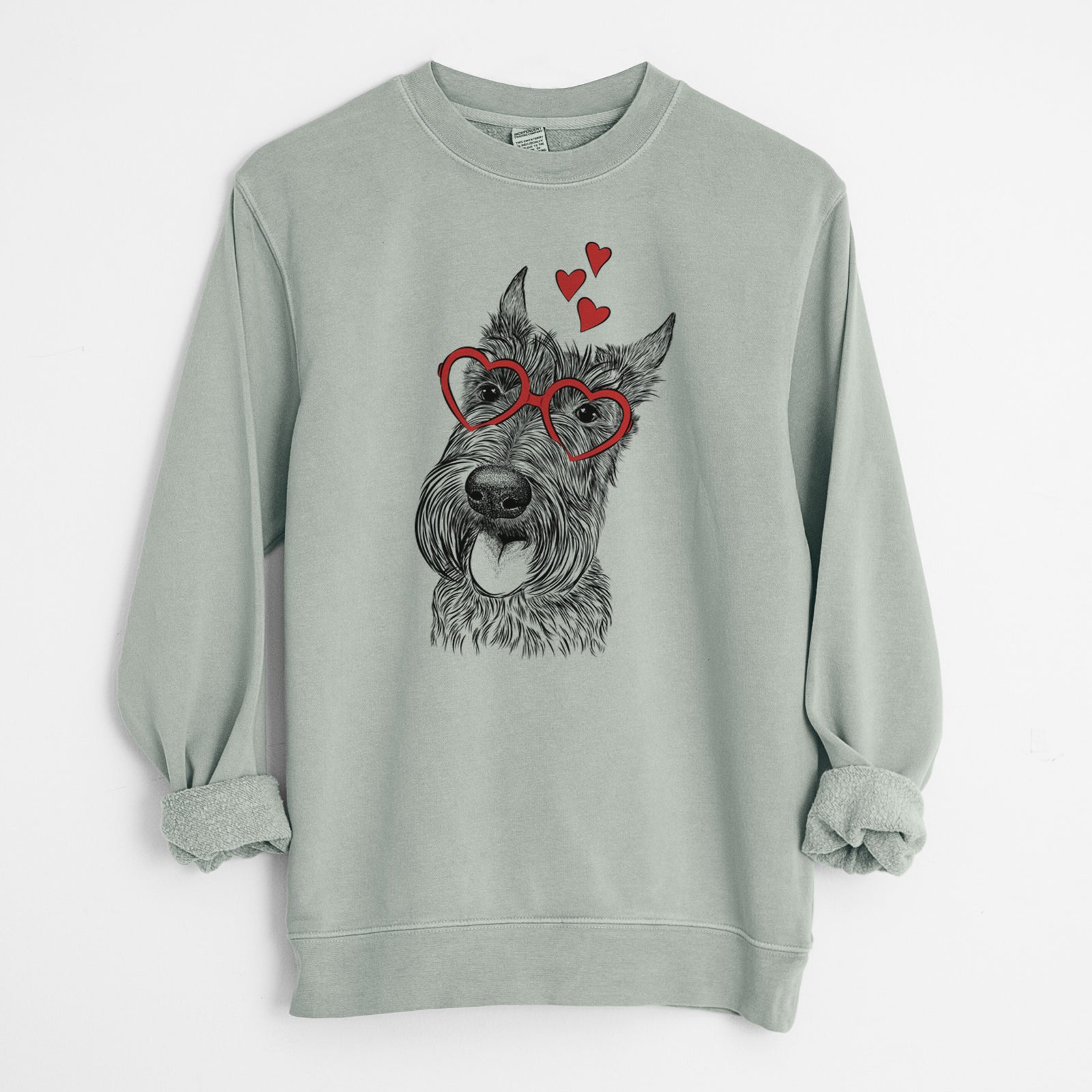 Hand-drawn sketch of Magnus the Scottish Terrier wearing heart-shaped glasses on a Sage Unisex pigment dyed crew sweatshirt