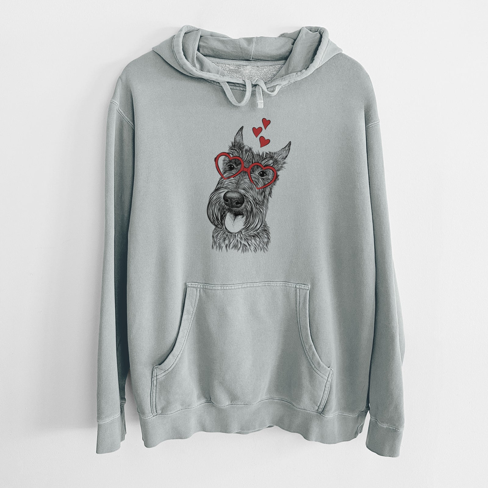 Hand-drawn sketch of Magnus the Scottish Terrier wearing heart-shaped glasses on a Sage Unisex pigment dyed hoodie