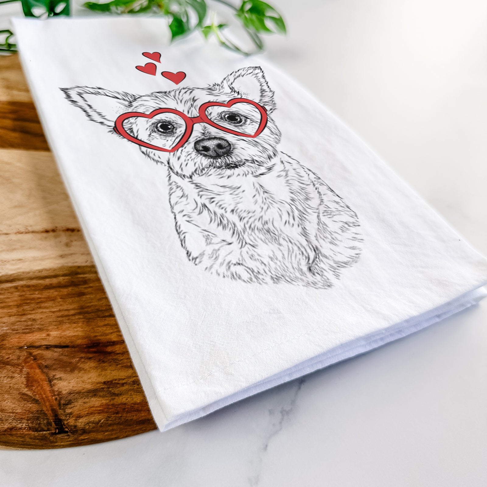 Hand-drawn sketch of Mango the Yorker Cairn Terrier Mix wearing heart-shaped glasses on a tea towel