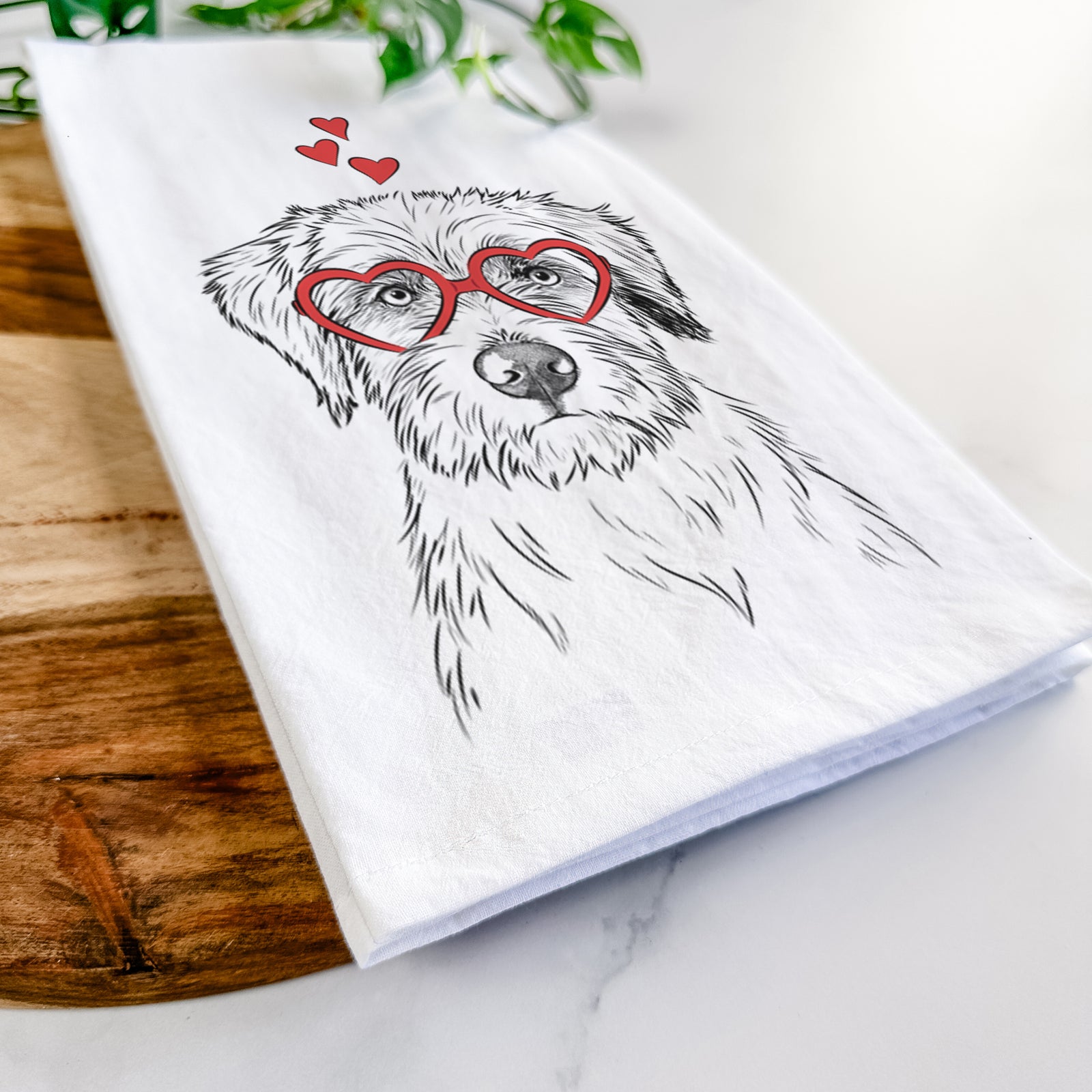 Hand-drawn sketch of Marek the Bernedoodle wearing heart-shaped glasses on a tea towel