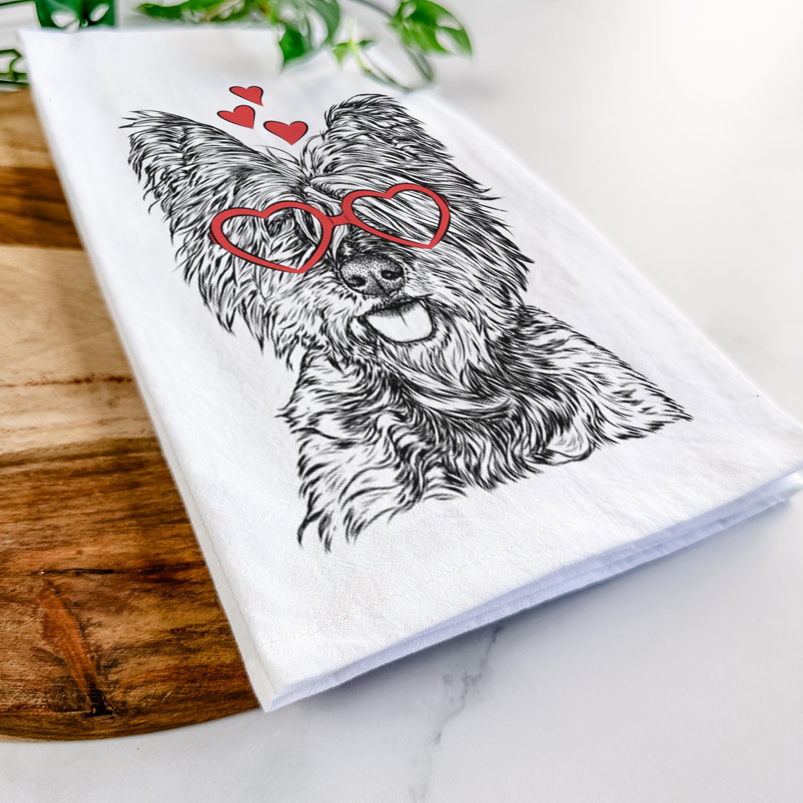Hand-drawn sketch of McDuff the Cairn Terrier wearing heart-shaped glasses on a tea towel
