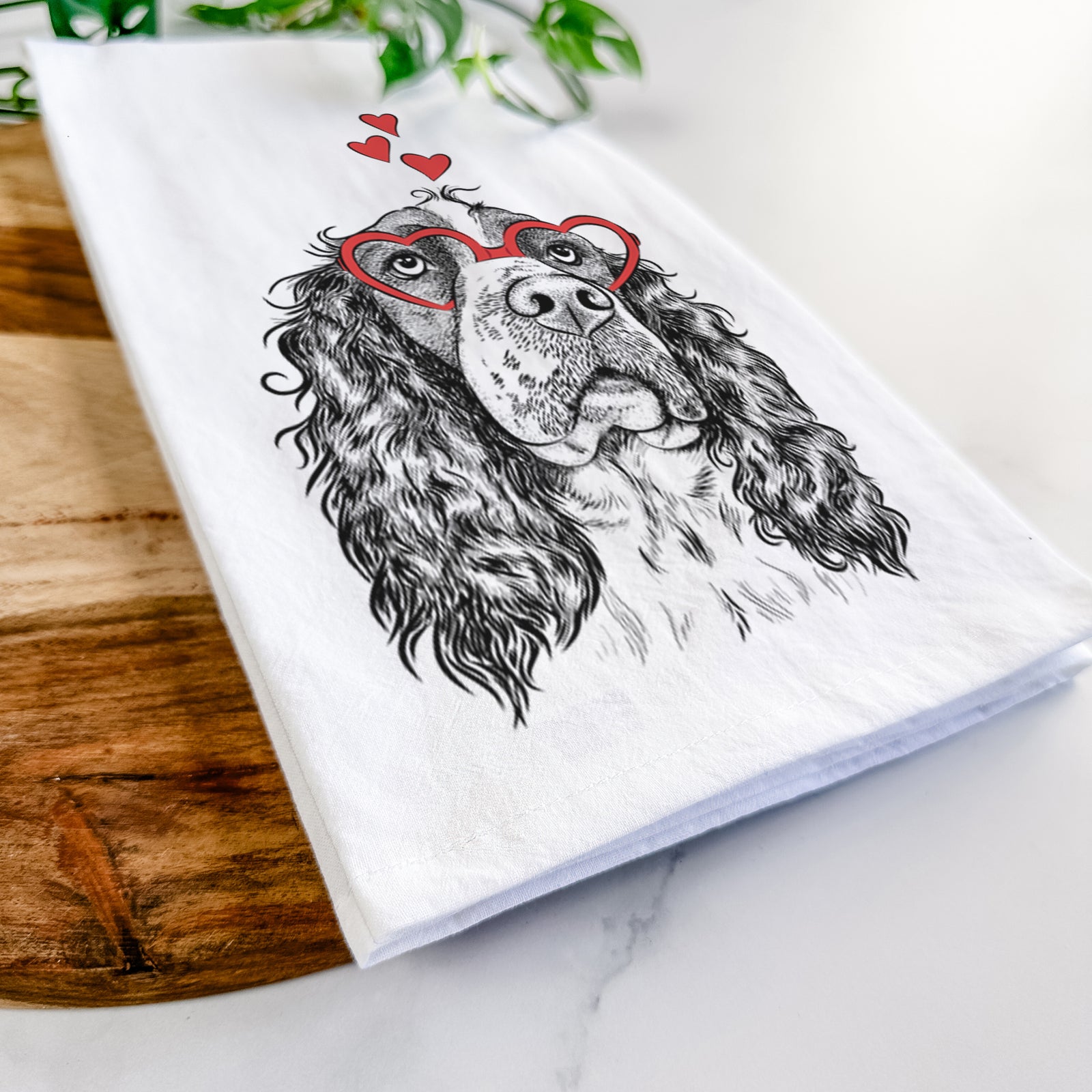 Hand-drawn sketch of Millie Mae the English Springer Spaniel wearing heart-shaped glasses on a tea towel