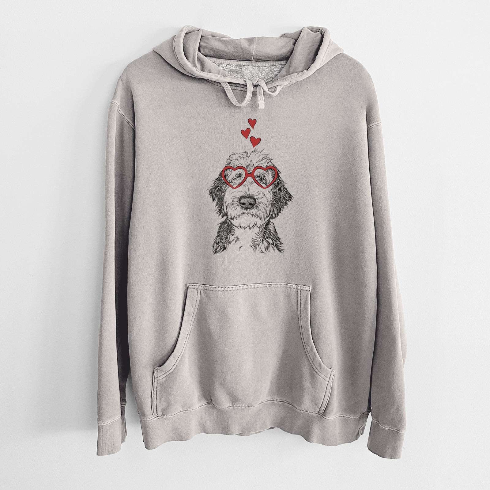 Hand-drawn sketch of Milo Fluff the Sheepadoodle wearing heart-shaped glasses on a Cement Unisex pigment dyed hoodie