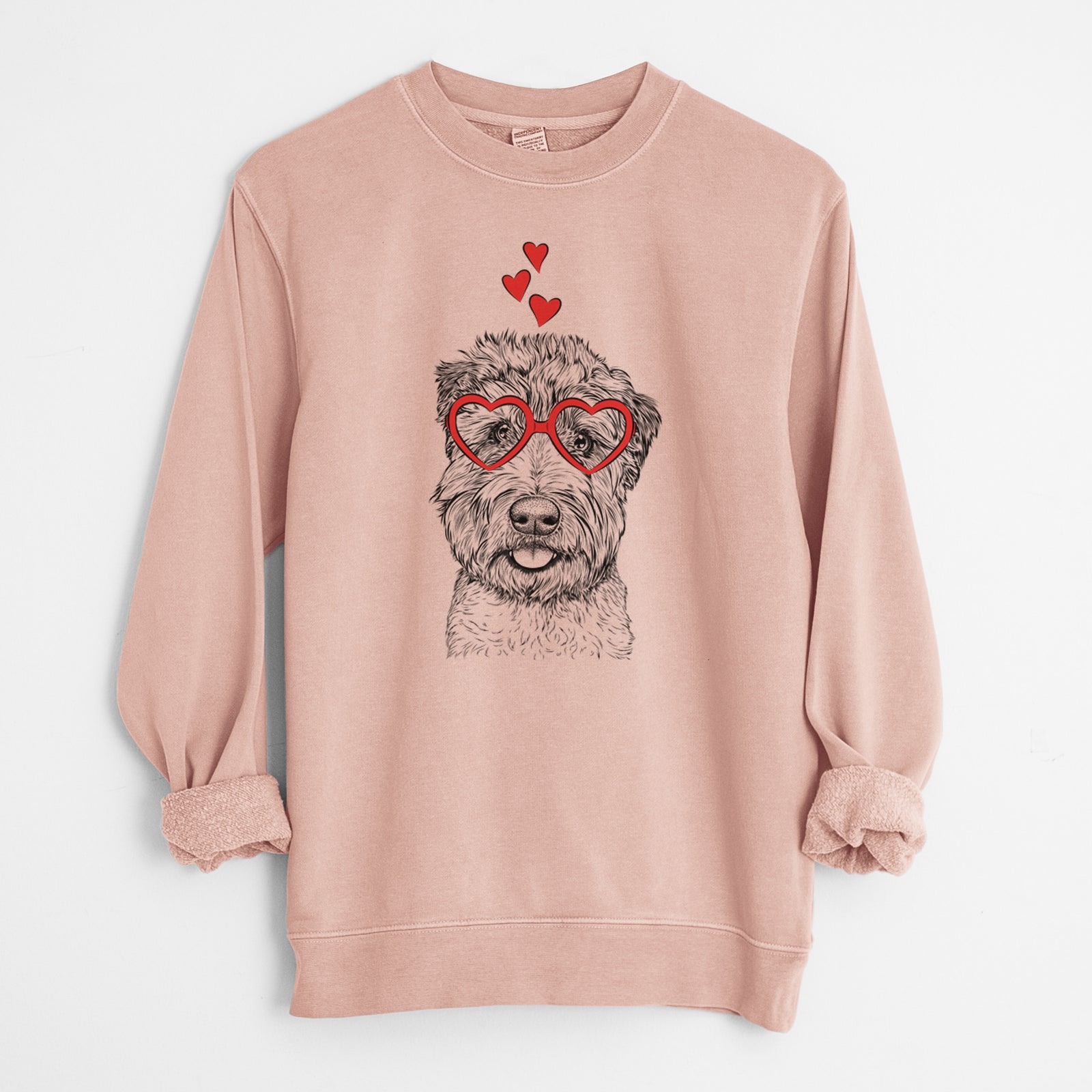 Hand-drawn sketch of Milton the Soft Coated Wheaten Terrier wearing heart-shaped glasses on a Dusty Pink Unisex pigment dyed crew sweatshirt