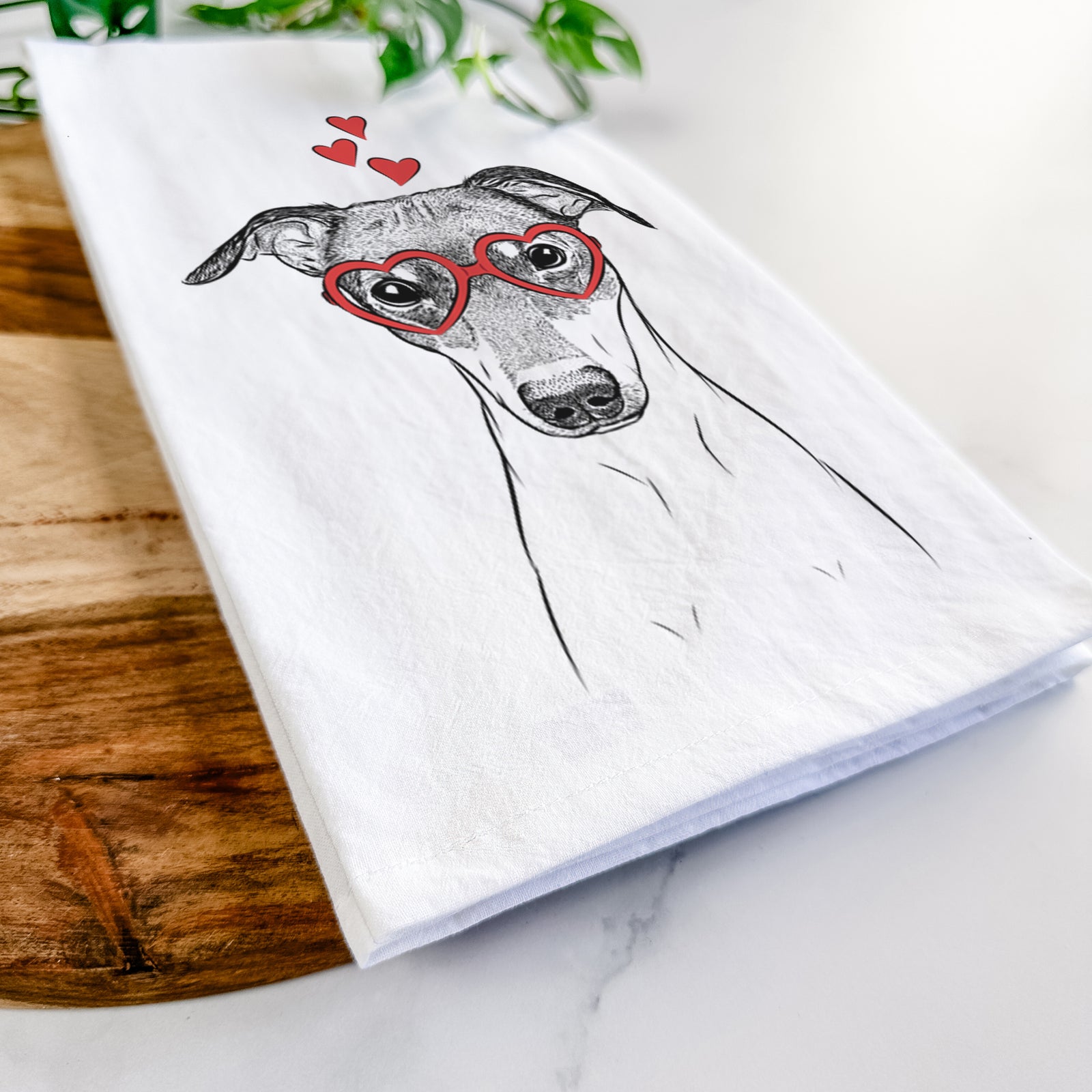 Hand-drawn sketch of Momo the Japanese Terrier wearing heart-shaped glasses on a tea towel