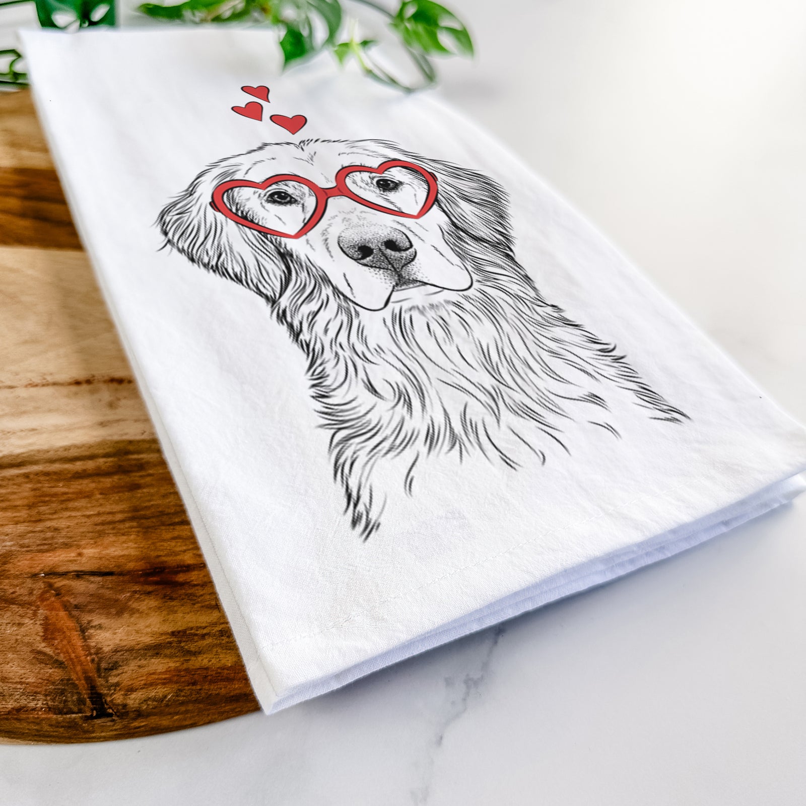 Hand-drawn sketch of Moose the Field Golden Retriever wearing heart-shaped glasses on a tea towel