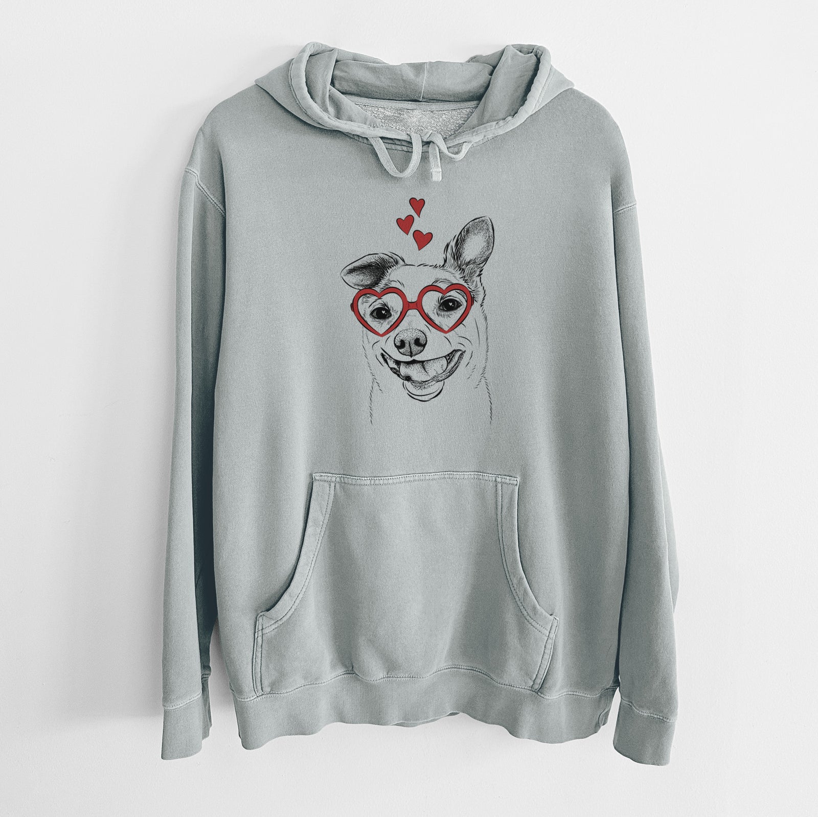 Hand-drawn sketch of Mortimer the Mixed Breed wearing heart-shaped glasses on a Sage Unisex pigment dyed hoodie