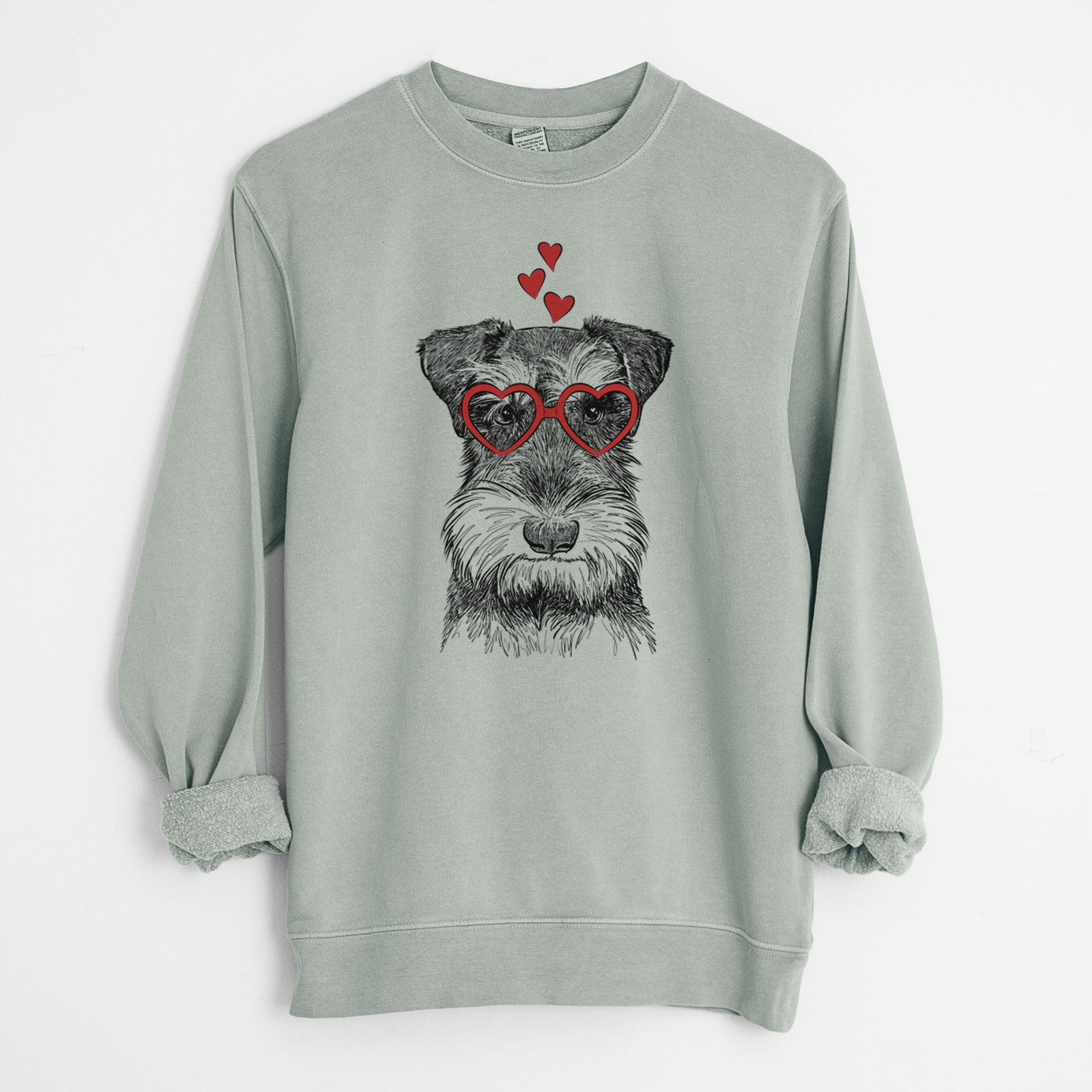 Hand-drawn sketch of Murphy the Mini Schnauzer wearing heart-shaped glasses on a Sage Unisex pigment dyed crew sweatshirt