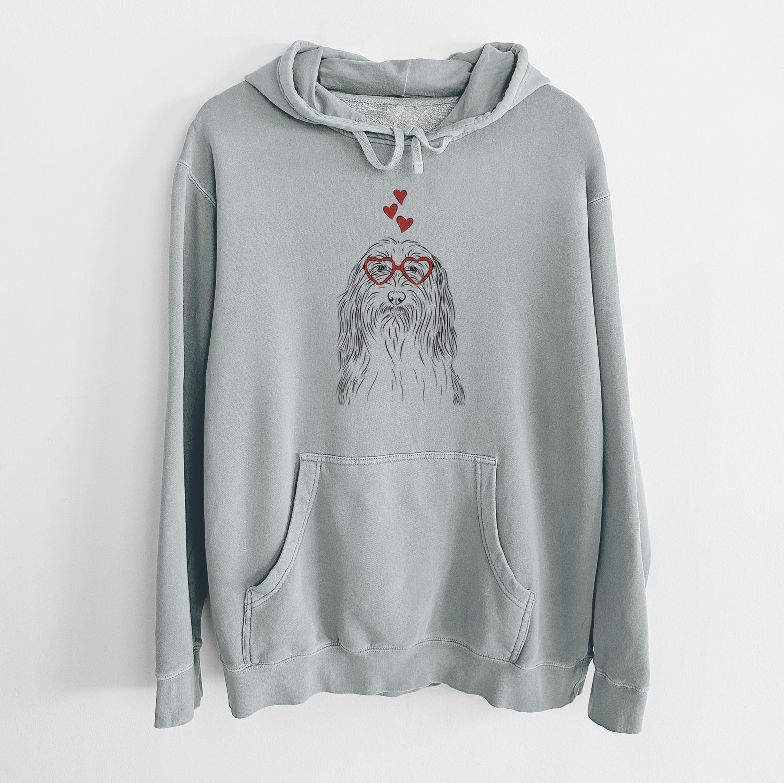 Hand-drawn sketch of Murray the Bearded Collie wearing heart-shaped glasses on a Sage Unisex pigment dyed hoodie