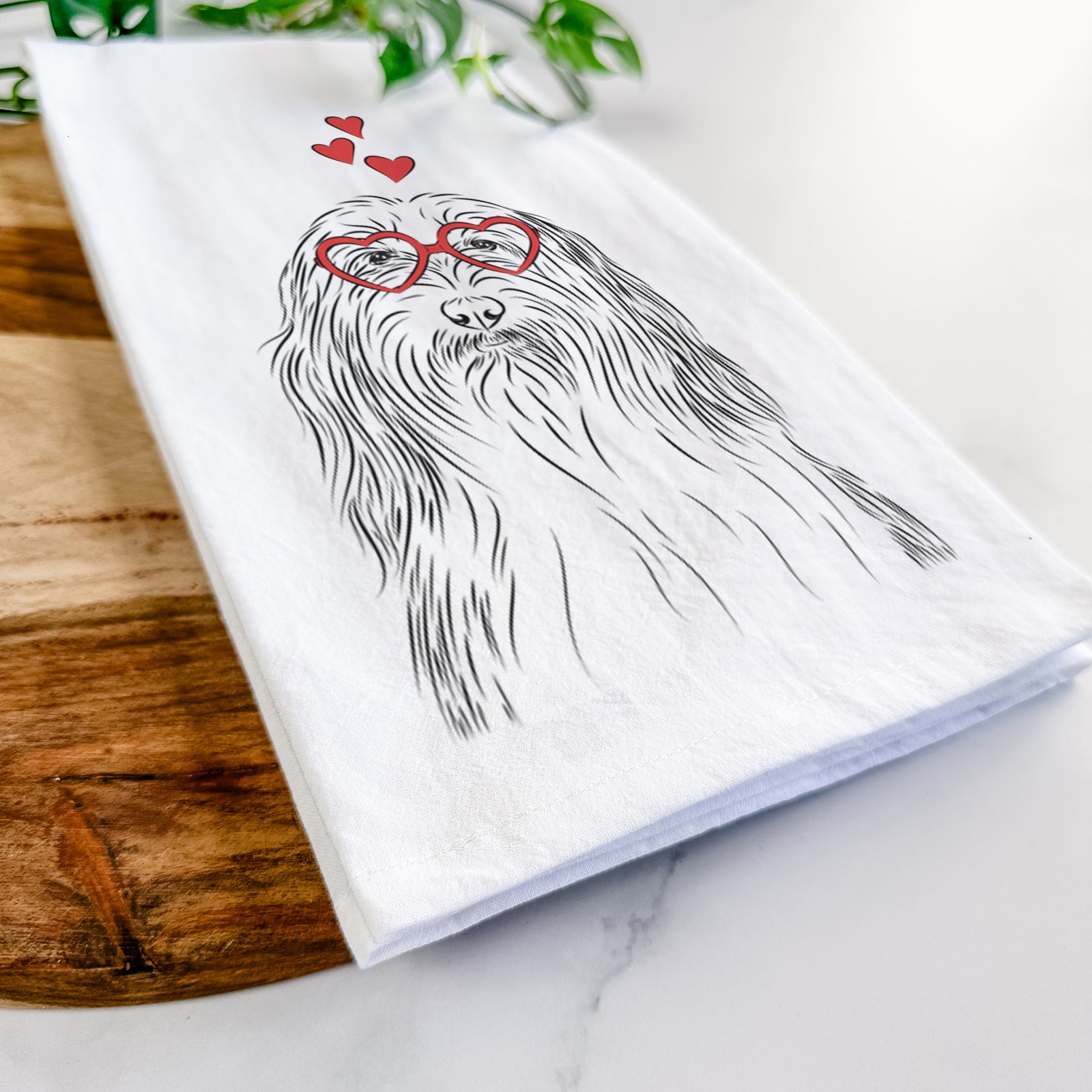 Hand-drawn sketch of Murray the Bearded Collie wearing heart-shaped glasses on a tea towel