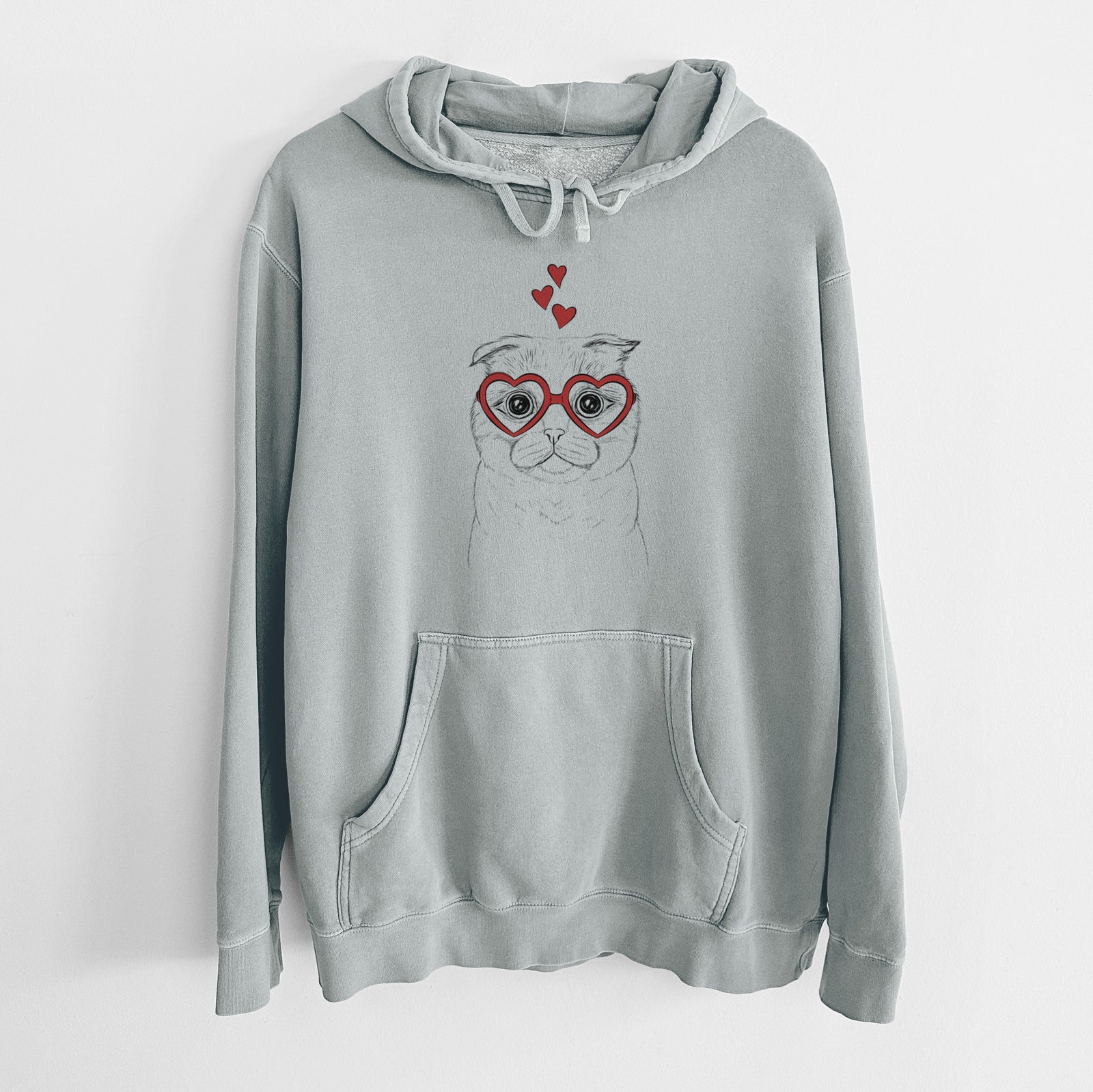Hand-drawn sketch of Neko the Scottish Fold Cat wearing heart-shaped glasses on a Sage Unisex pigment dyed hoodie