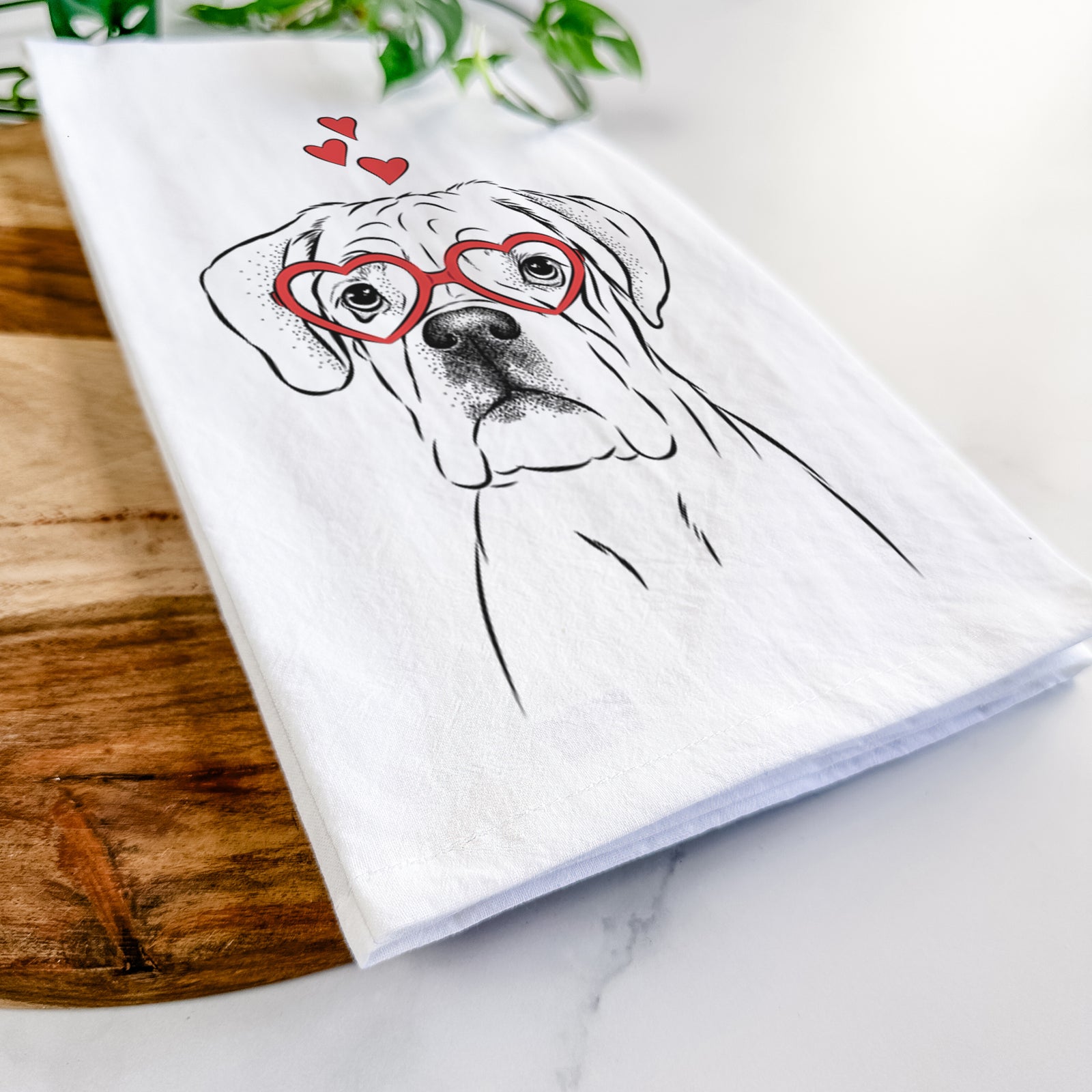 Hand-drawn sketch of Nelly the Boxer wearing heart-shaped glasses on a tea towel