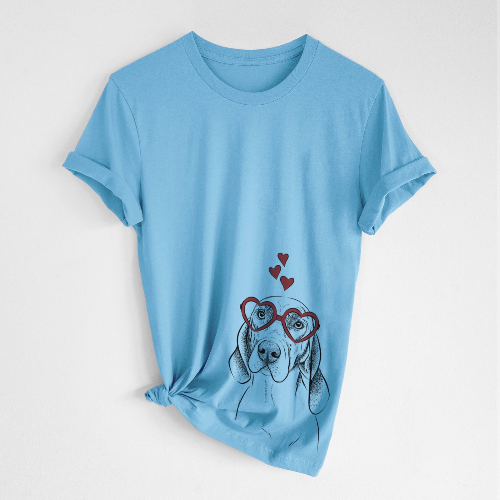 Hand-drawn sketch of Norman the Plott Hound wearing heart-shaped glasses on an Ocean Blue Unisex crewneck, worn by a woman