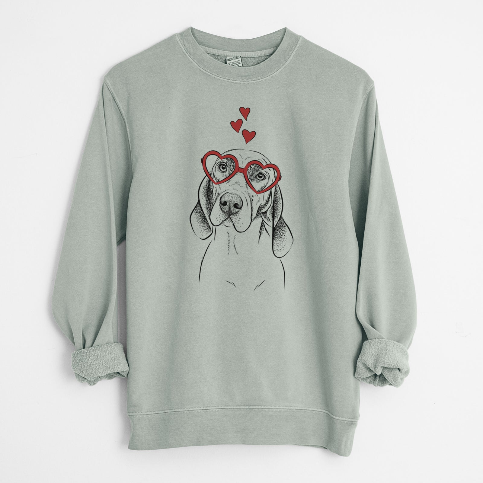 Hand-drawn sketch of Norman the Plott Hound wearing heart-shaped glasses on a Sage Unisex pigment dyed crew sweatshirt