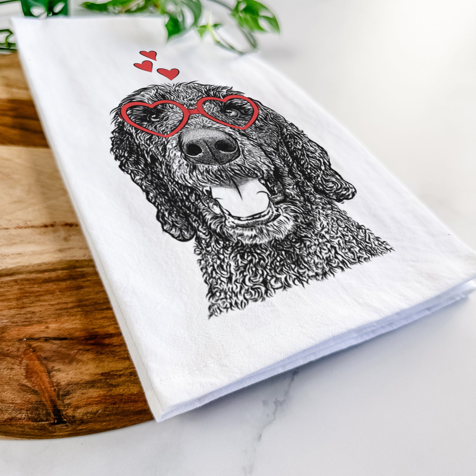Hand-drawn sketch of Obi James the Goldendoodle wearing heart-shaped glasses on a tea towel