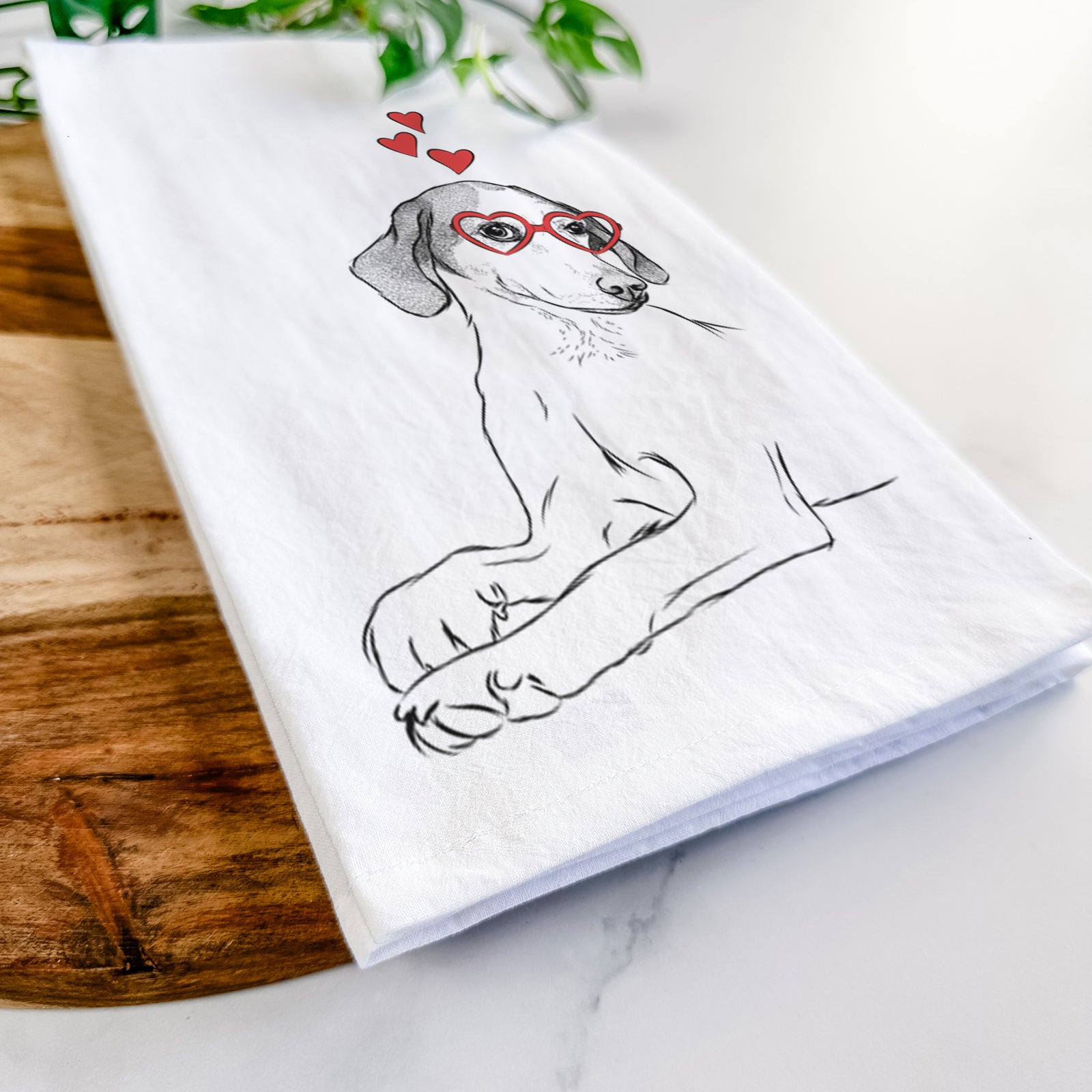 Hand-drawn sketch of Opie the Foxhound wearing heart-shaped glasses on a tea towel