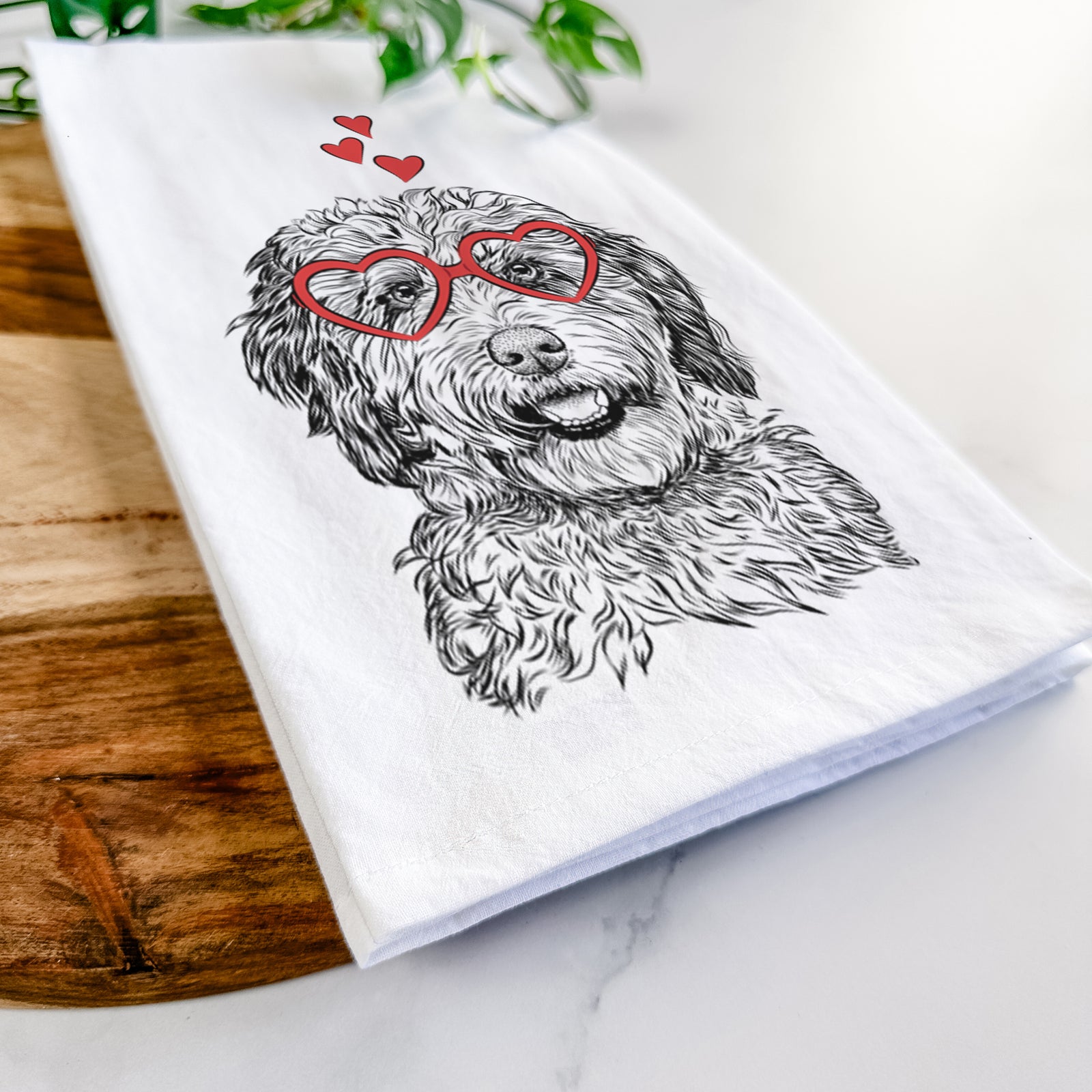 Hand-drawn sketch of Palmer the Aussiedoodle wearing heart-shaped glasses on a tea towel