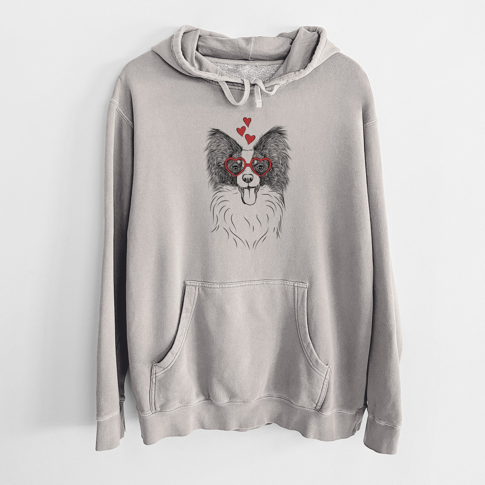 Hand-drawn sketch of Patrick the Papillon wearing heart-shaped glasses on a Cement Unisex pigment dyed hoodie