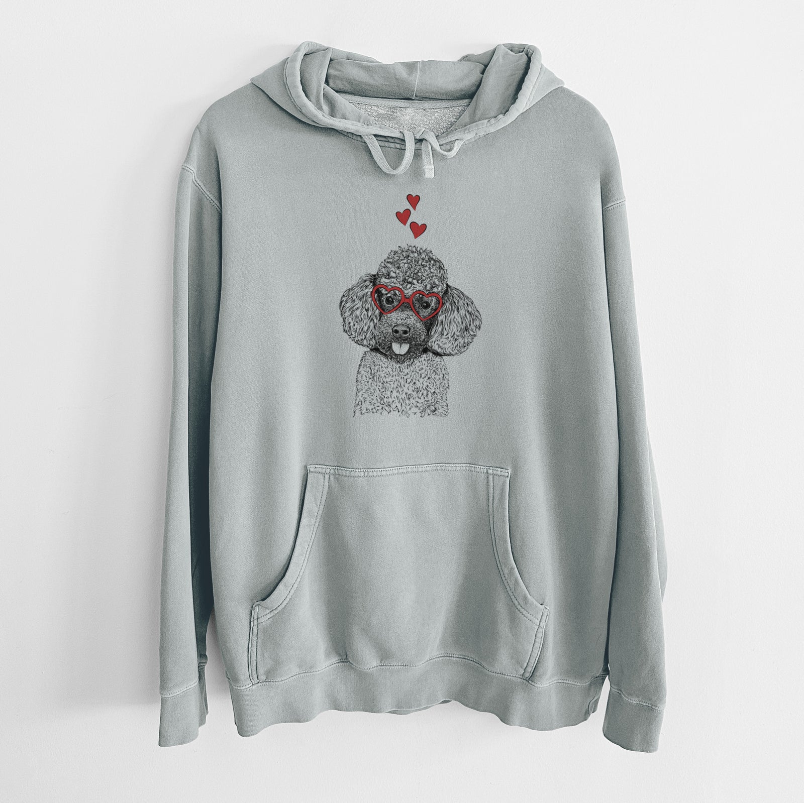 Hand-drawn sketch of George the Toy Poodle wearing heart-shaped glasses on a Sage Unisex pigment dyed hoodie