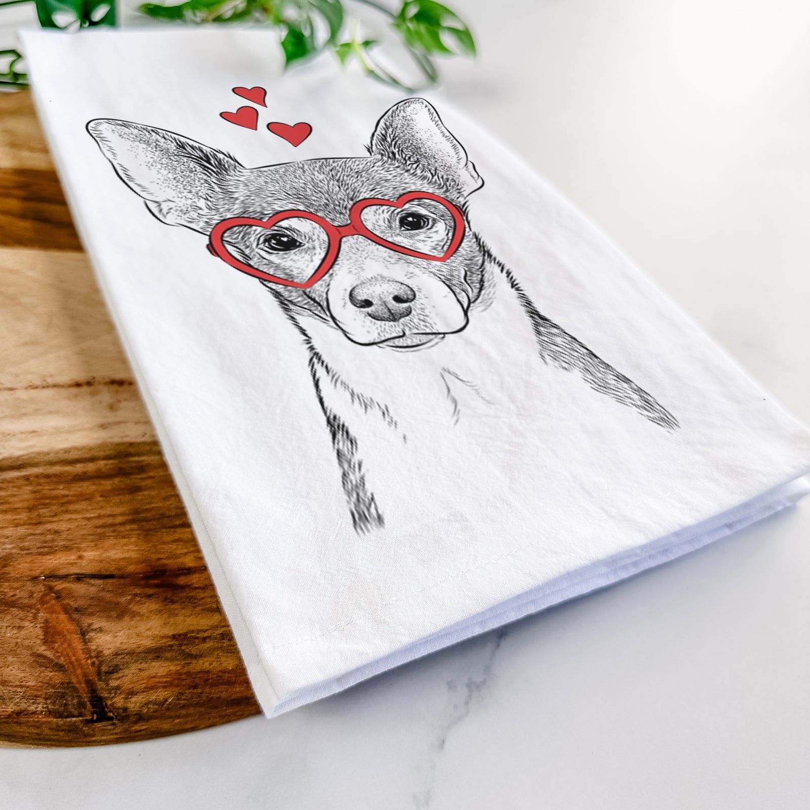 Hand-drawn sketch of Peanut the Chihuahua wearing heart-shaped glasses on a tea towel