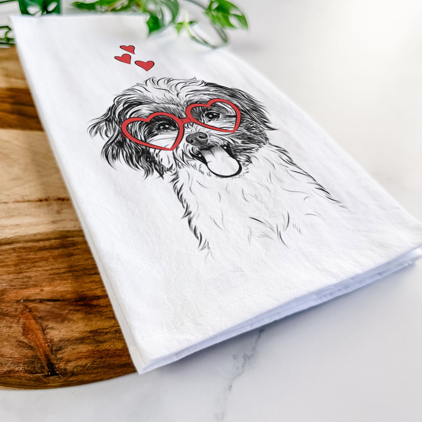 Hand-drawn sketch of Pepper the Shihpoo wearing heart-shaped glasses on a tea towel