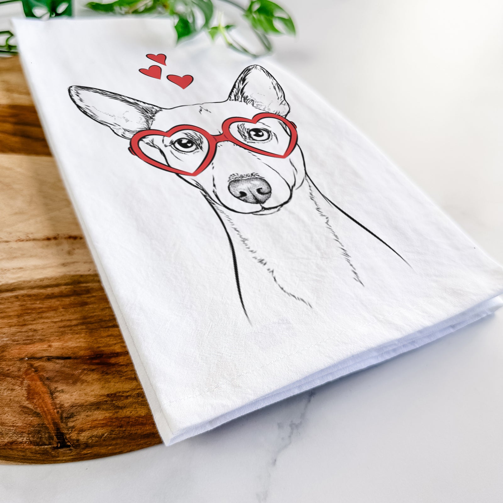 Hand-drawn sketch of Perry the Portuguese Podengo wearing heart-shaped glasses on a tea towel