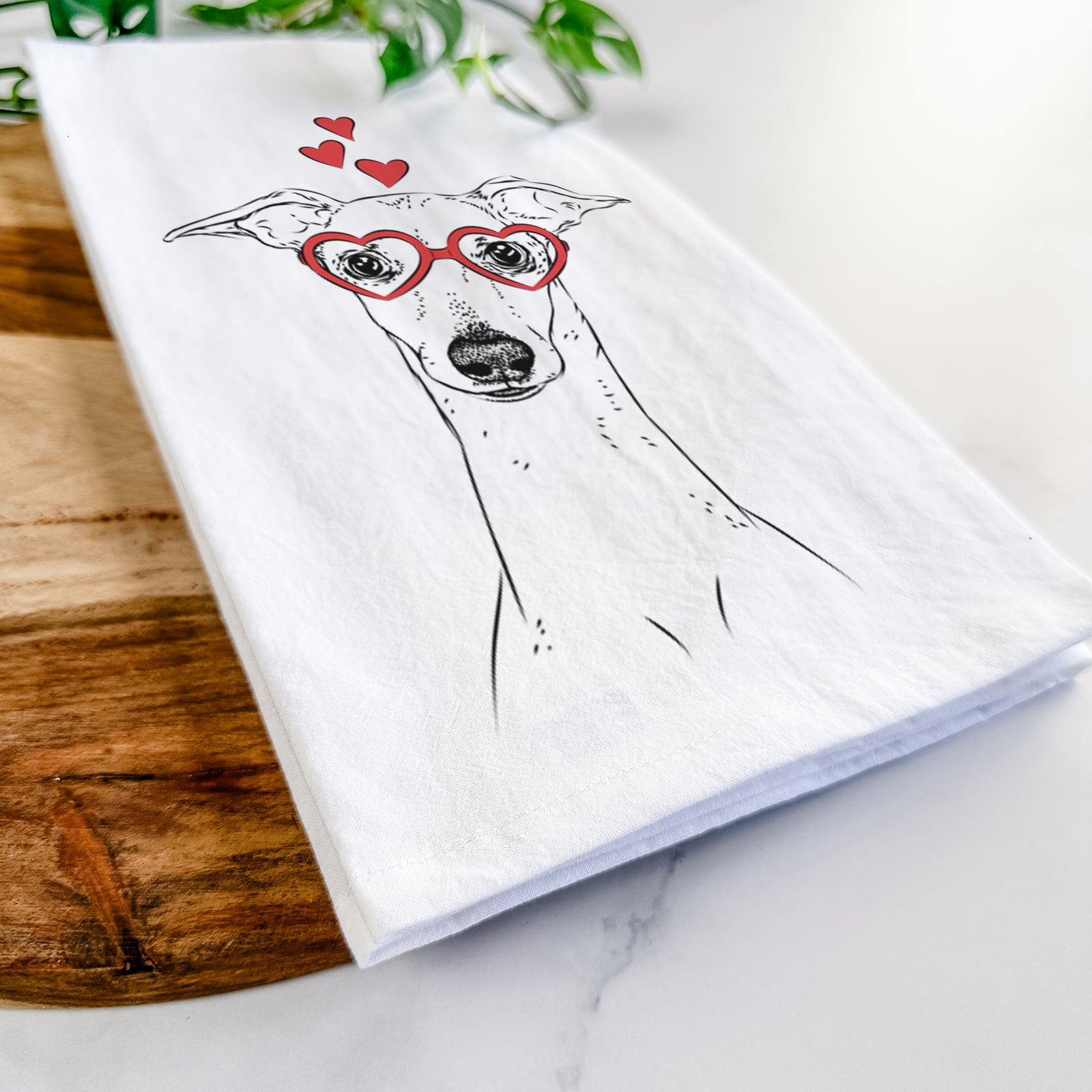 Hand-drawn sketch of Pip the Italian Greyhound wearing heart-shaped glasses on a tea towel