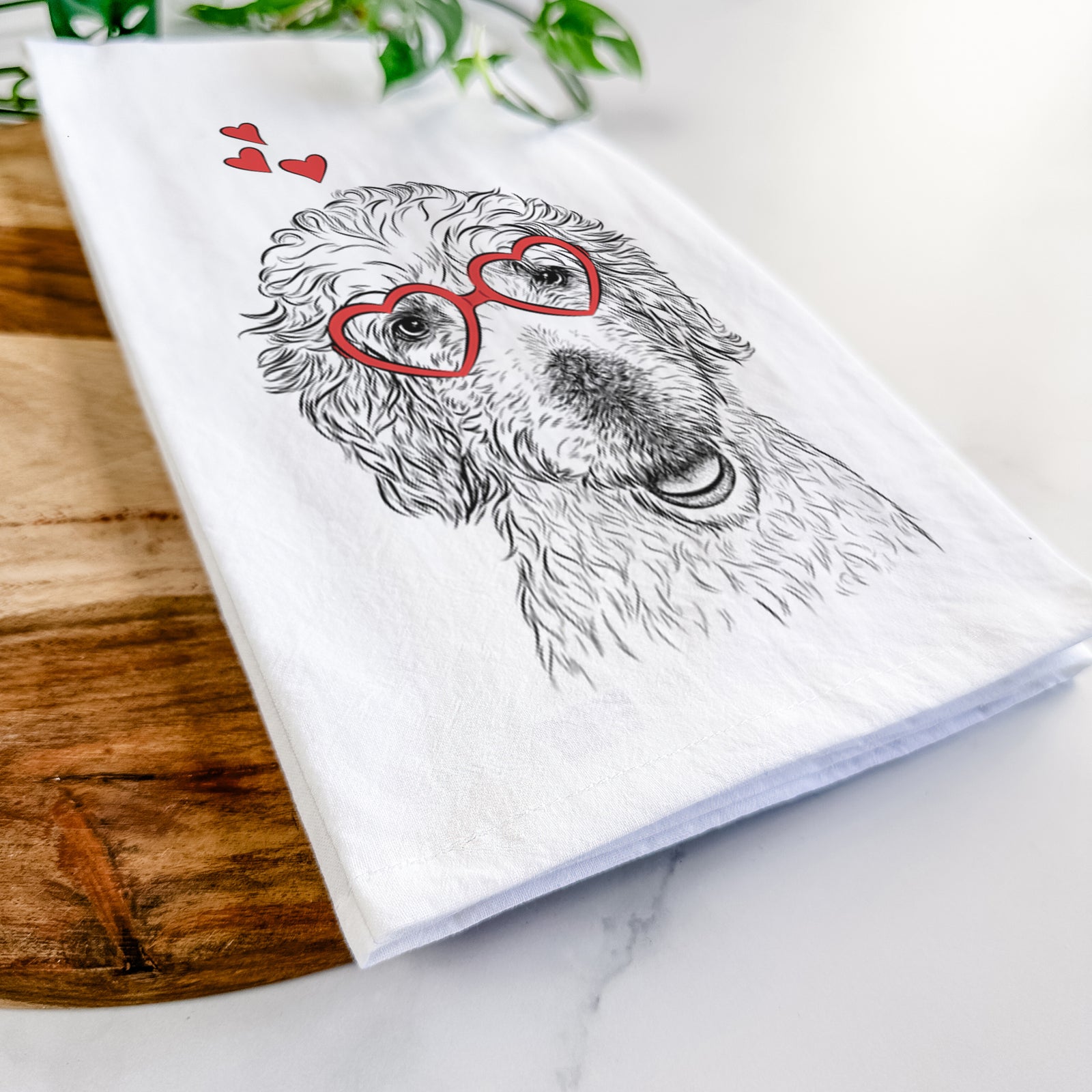 Hand-drawn sketch of Preston the Labradoodle wearing heart-shaped glasses on a tea towel