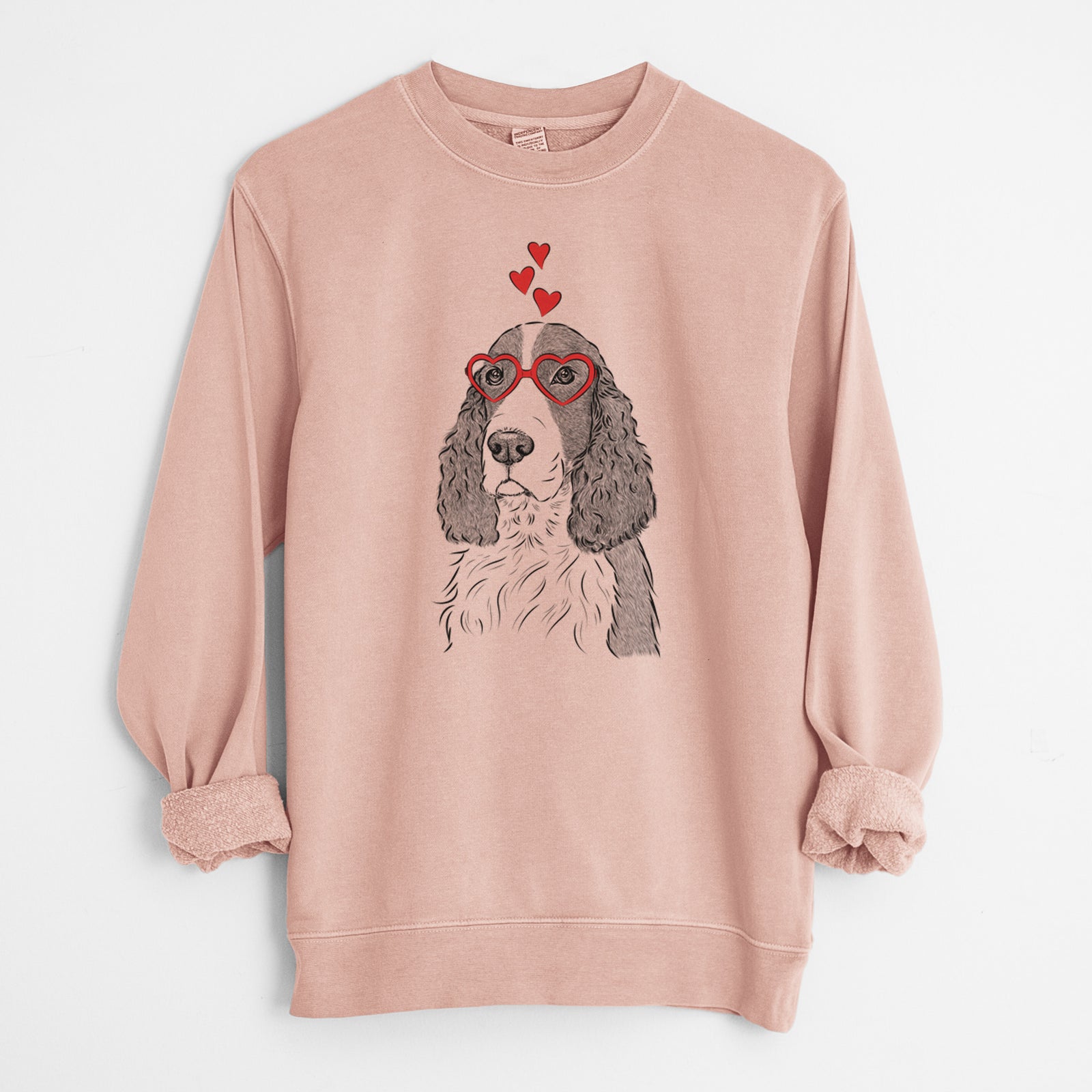 Hand-drawn sketch of Quincy the English Springer Spaniel wearing heart-shaped glasses on a Dusty Pink Unisex pigment dyed crew sweatshirt