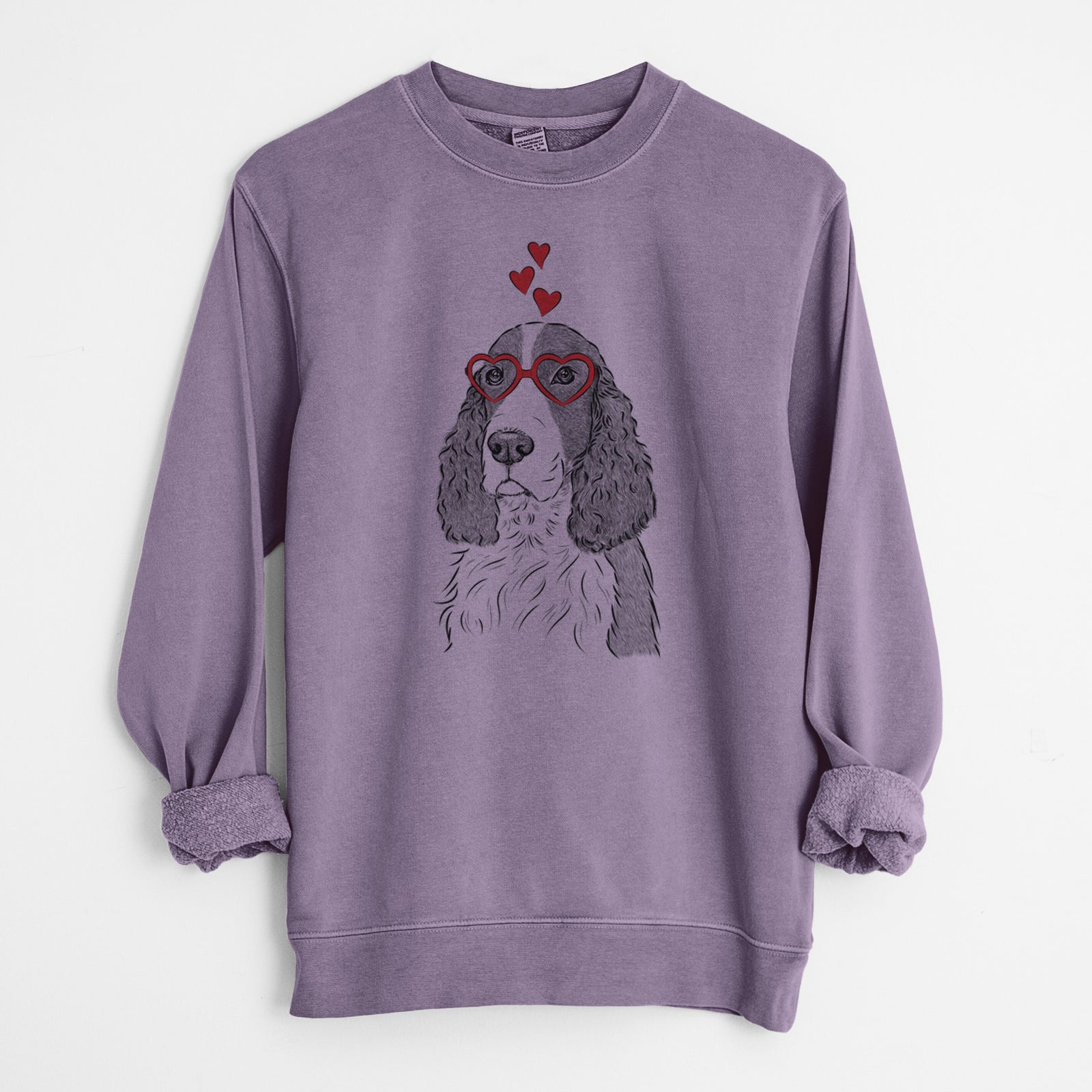 Hand-drawn sketch of Quincy the English Springer Spaniel wearing heart-shaped glasses on a Plum Unisex pigment dyed crew sweatshirt