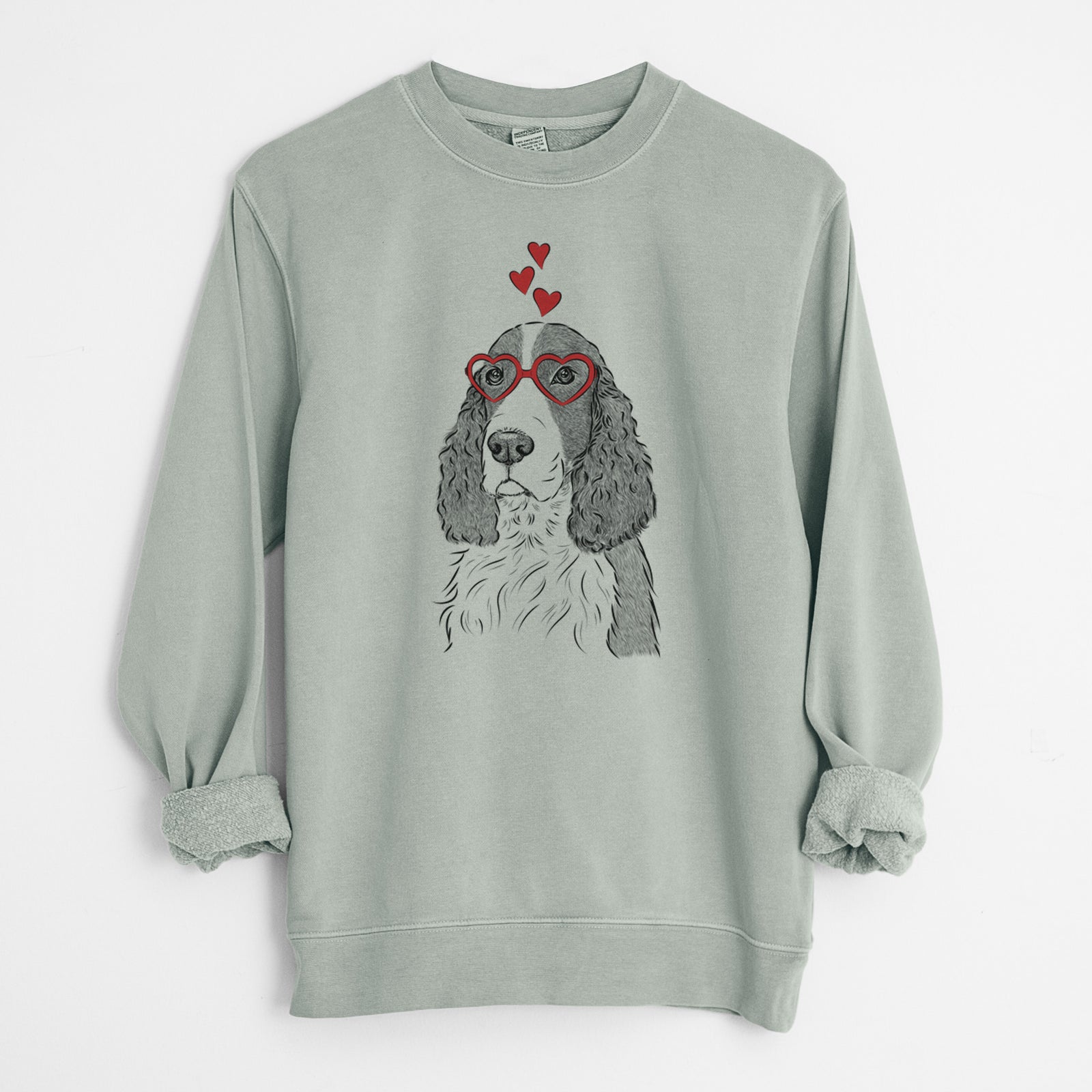 Hand-drawn sketch of Quincy the English Springer Spaniel wearing heart-shaped glasses on a Sage Unisex pigment dyed crew sweatshirt