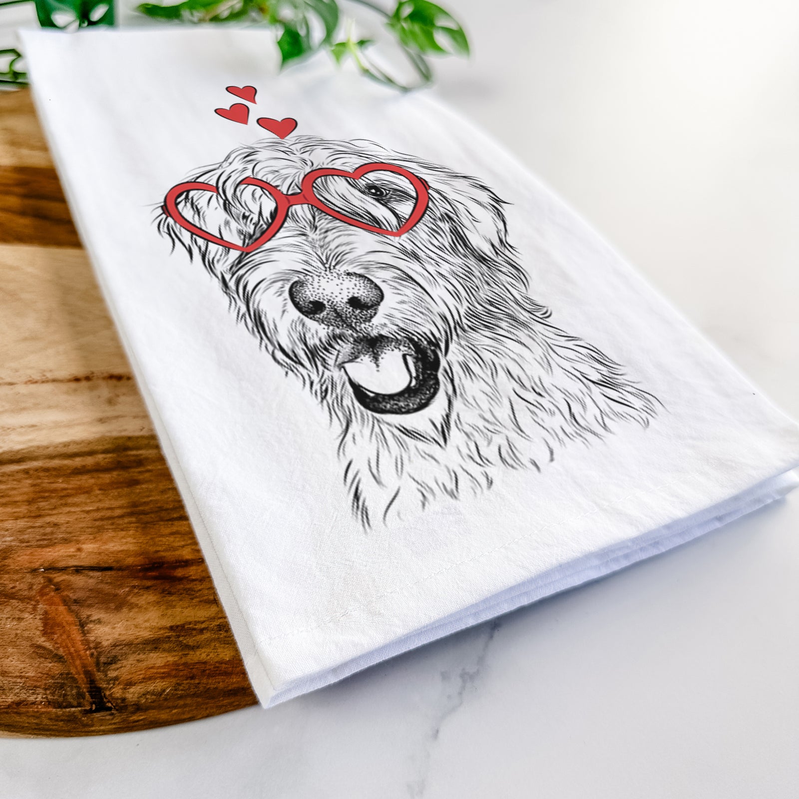 Hand-drawn sketch of Ragnar the Irish Wolfhound wearing heart-shaped glasses on a tea towel
