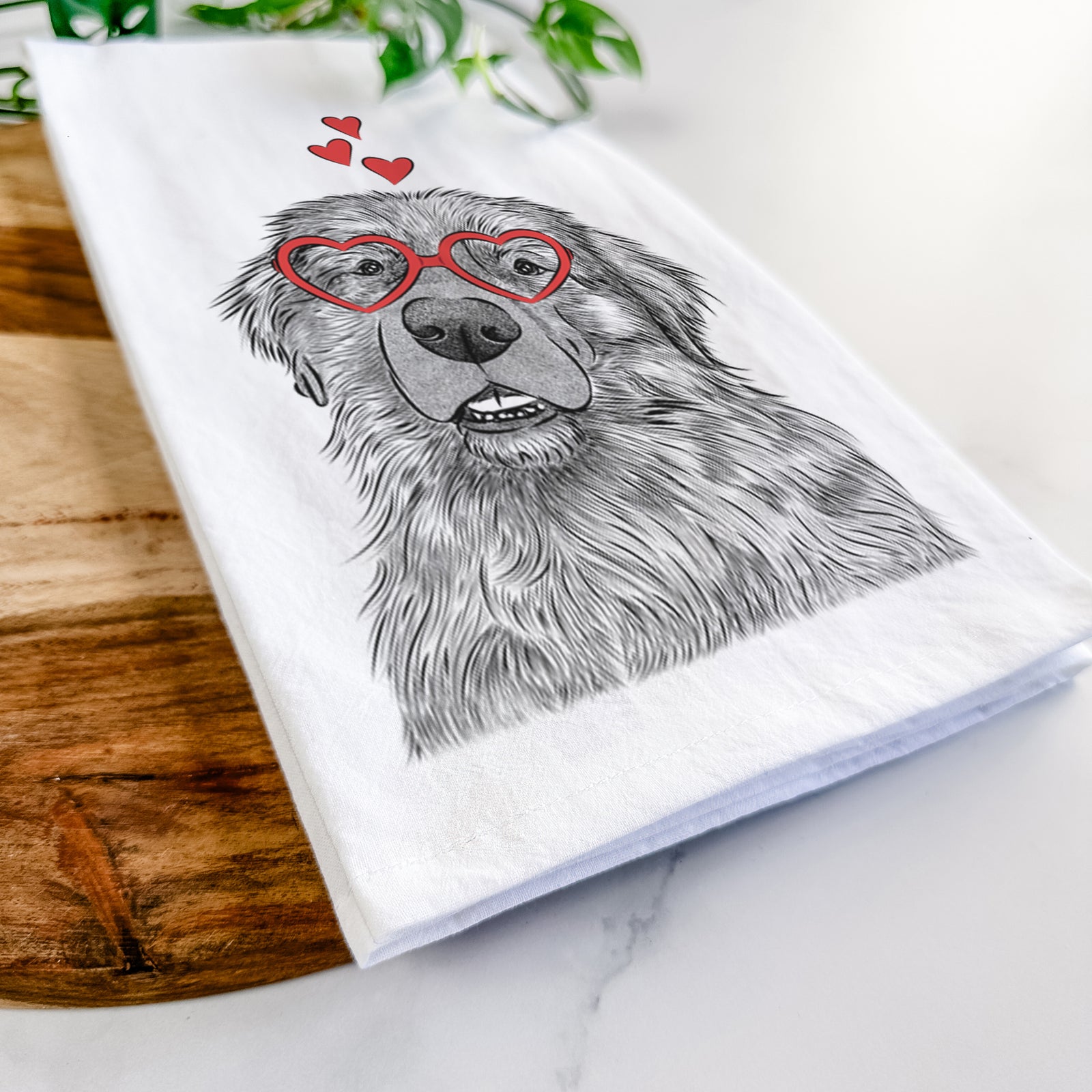 Hand-drawn sketch of Ralph the Leonberger wearing heart-shaped glasses on a tea towel