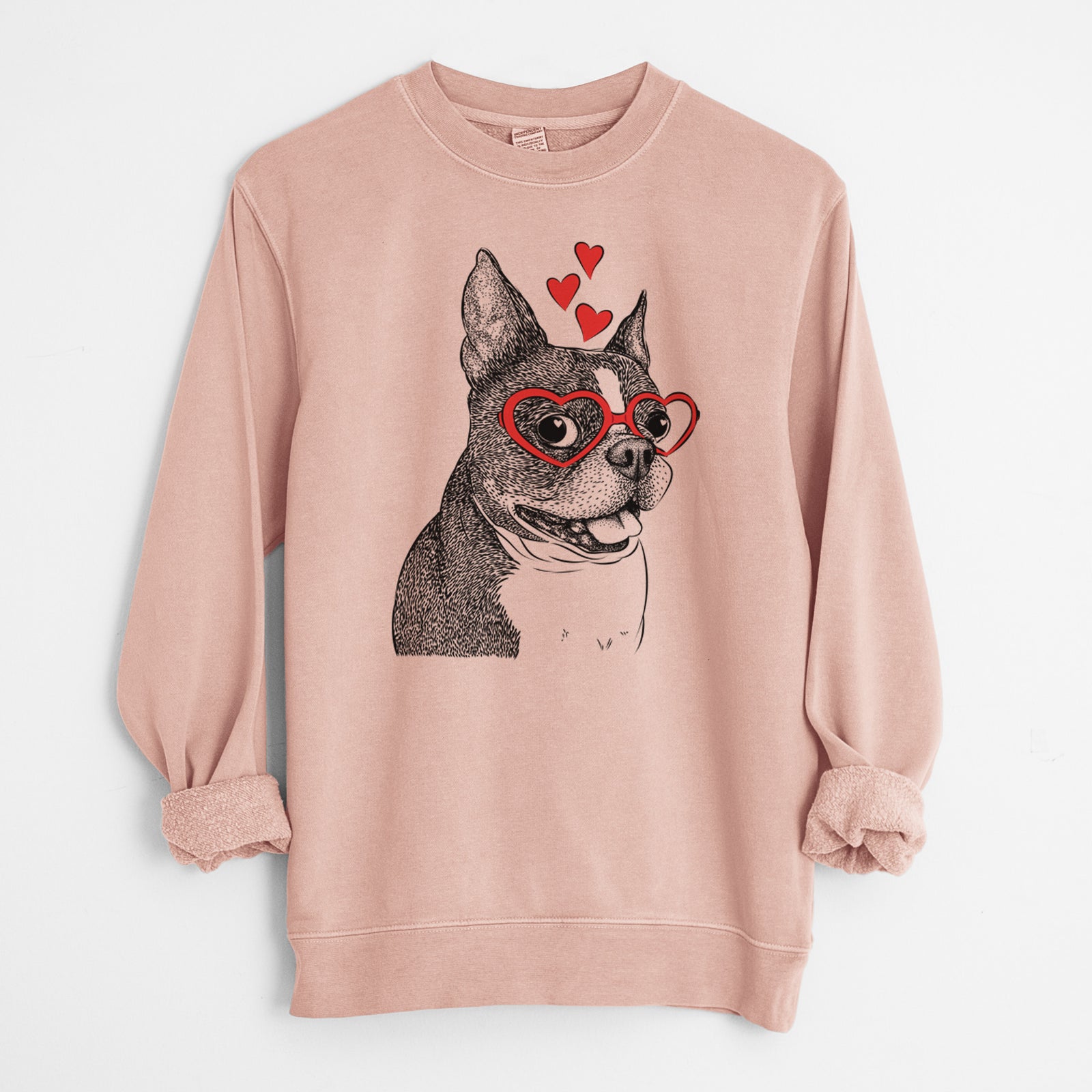 Hand-drawn sketch of Ralphie the Boston Terrier wearing heart-shaped glasses on a Dusty Pink Unisex pigment dyed crew sweatshirt