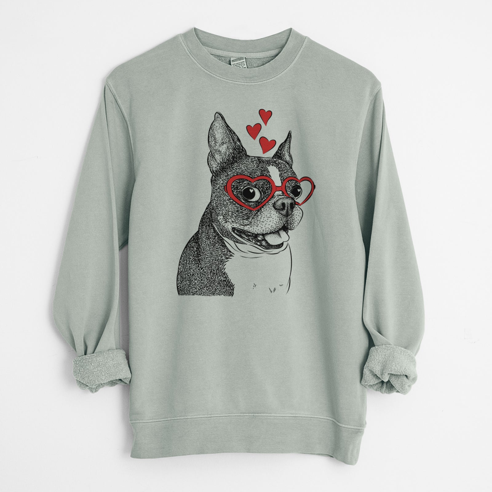 Hand-drawn sketch of Ralphie the Boston Terrier wearing heart-shaped glasses on a Sage Unisex pigment dyed crew sweatshirt