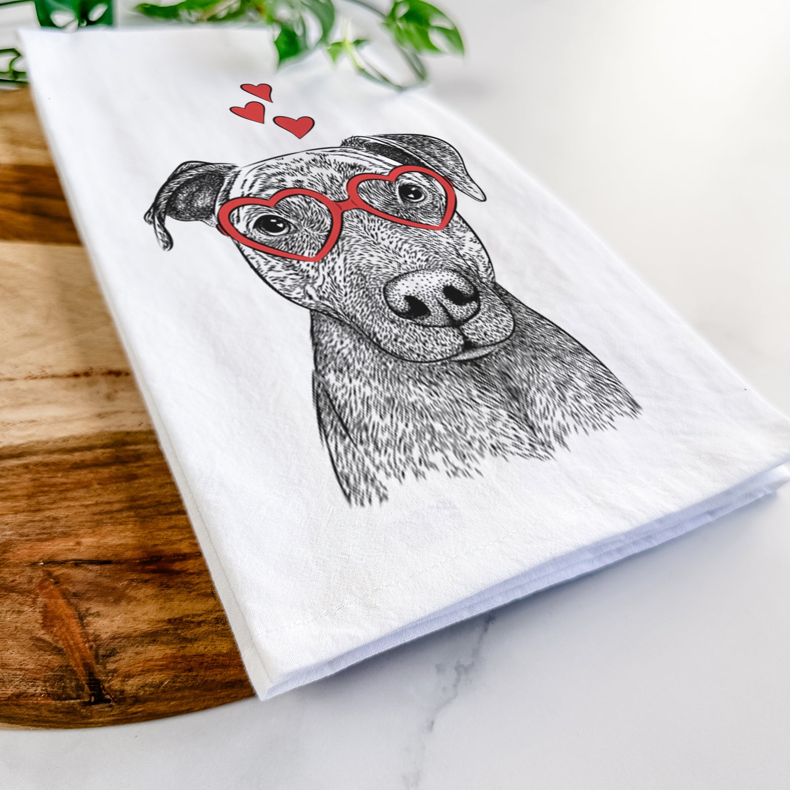 Hand-drawn sketch of Reeses the Pitbull wearing heart-shaped glasses on a tea towel