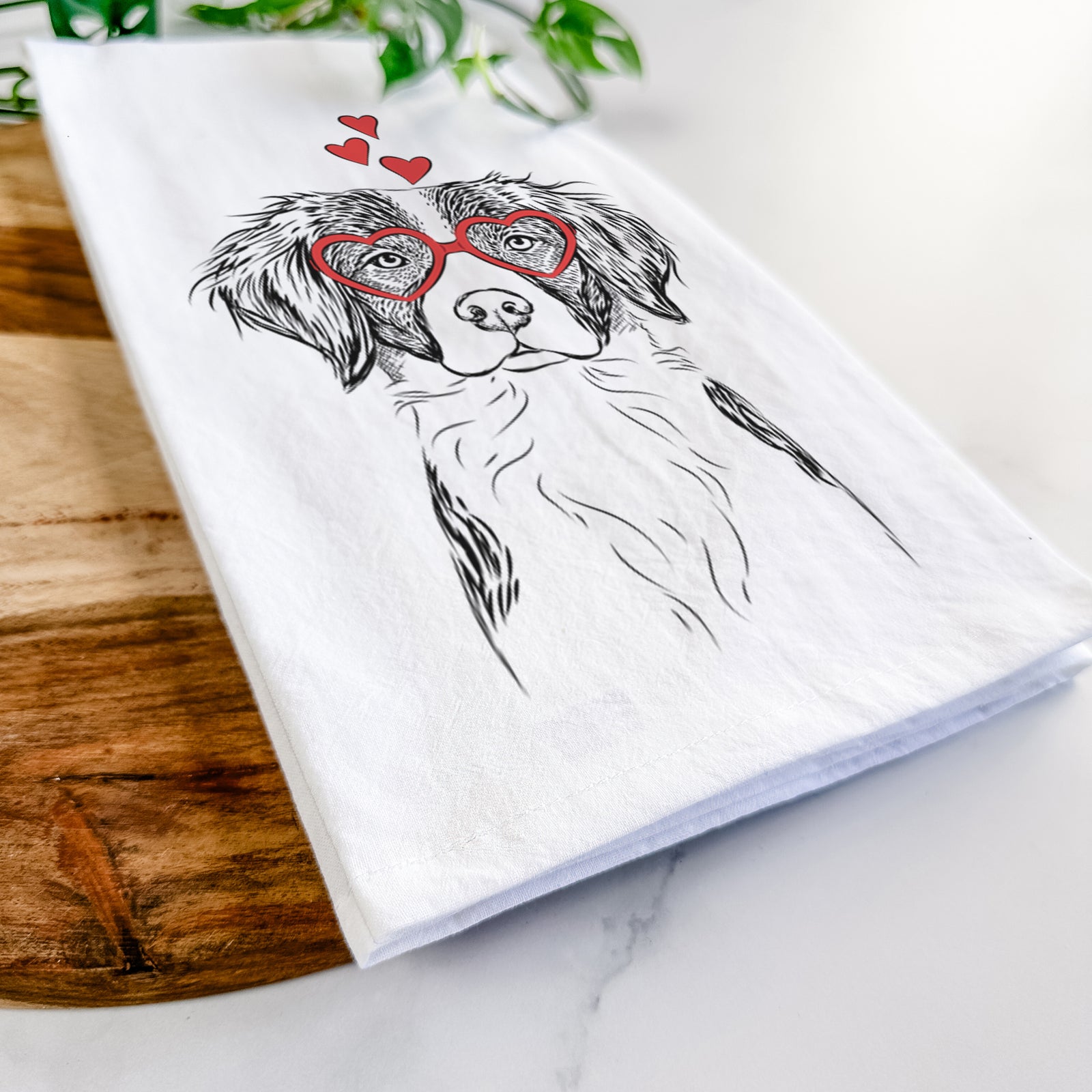 Hand-drawn sketch of Remi the Brittany wearing heart-shaped glasses on a tea towel