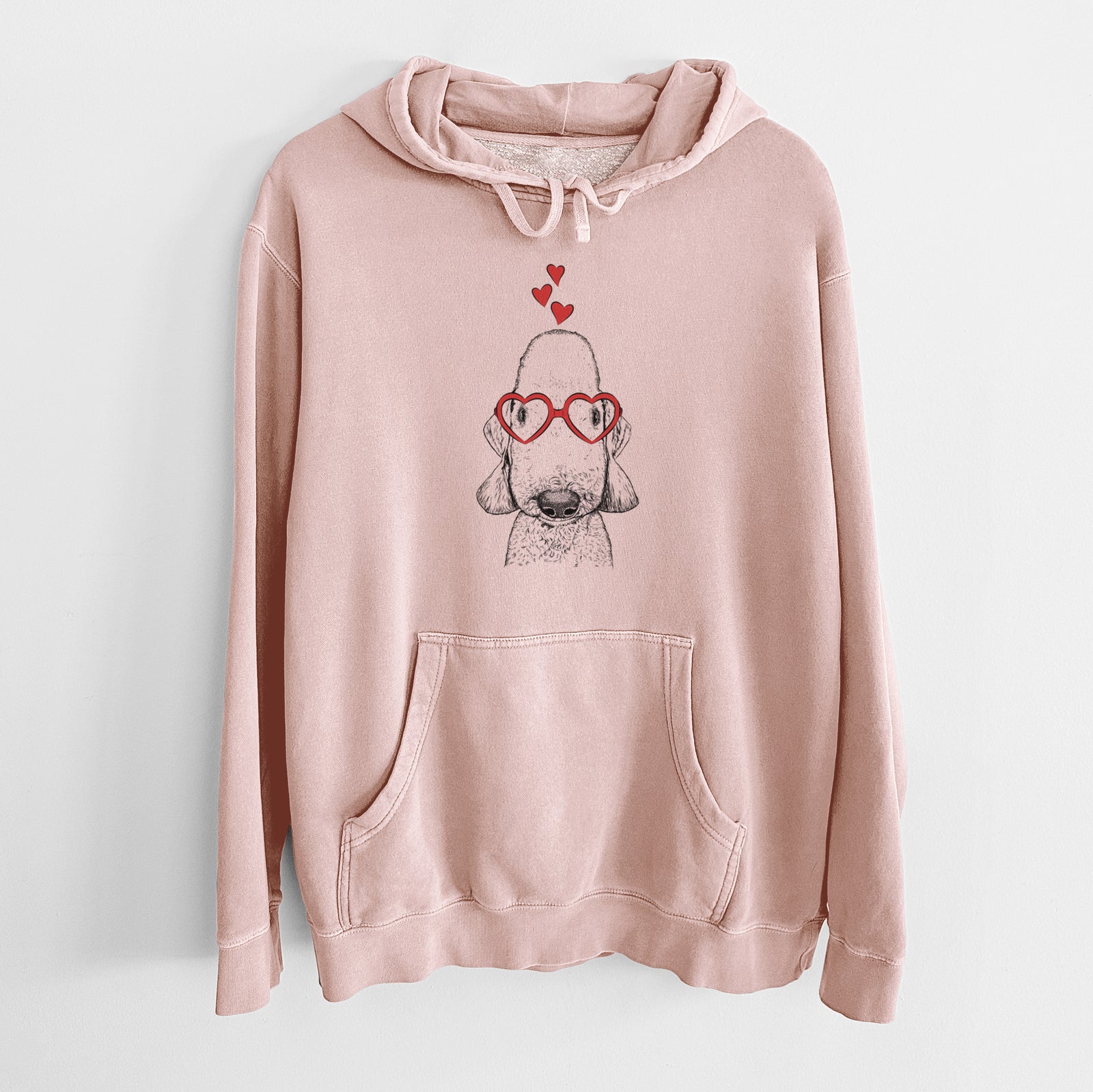 Hand-drawn sketch of Remington the Bedlington Terrier wearing heart-shaped glasses on a Dusty Pink Unisex pigment dyed hoodie