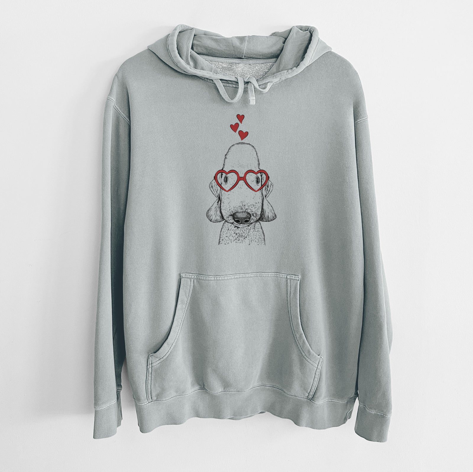 Hand-drawn sketch of Remington the Bedlington Terrier wearing heart-shaped glasses on a Sage Unisex pigment dyed hoodie
