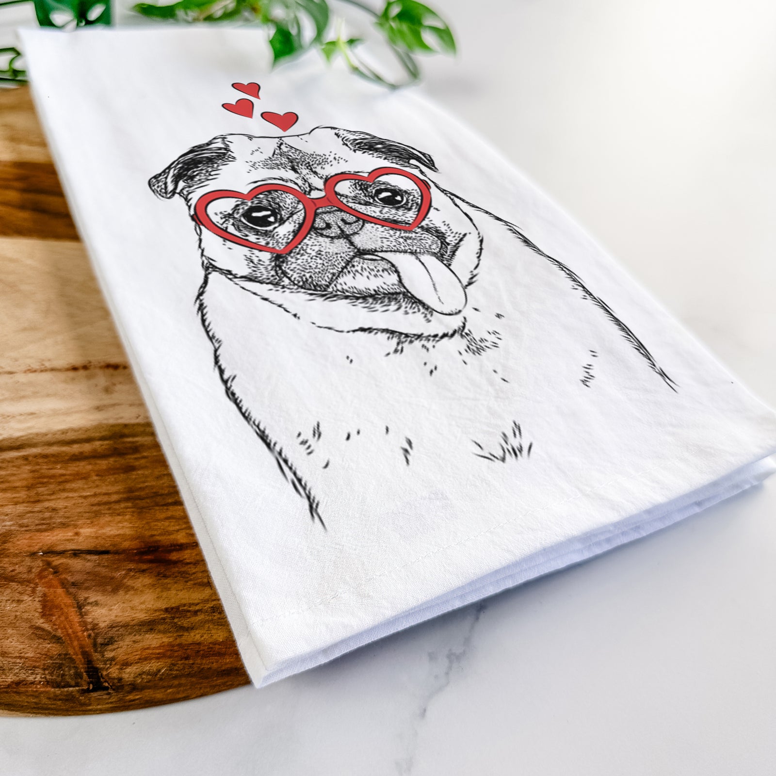 Hand-drawn sketch of Rosie the Pug wearing heart-shaped glasses on a tea towel
